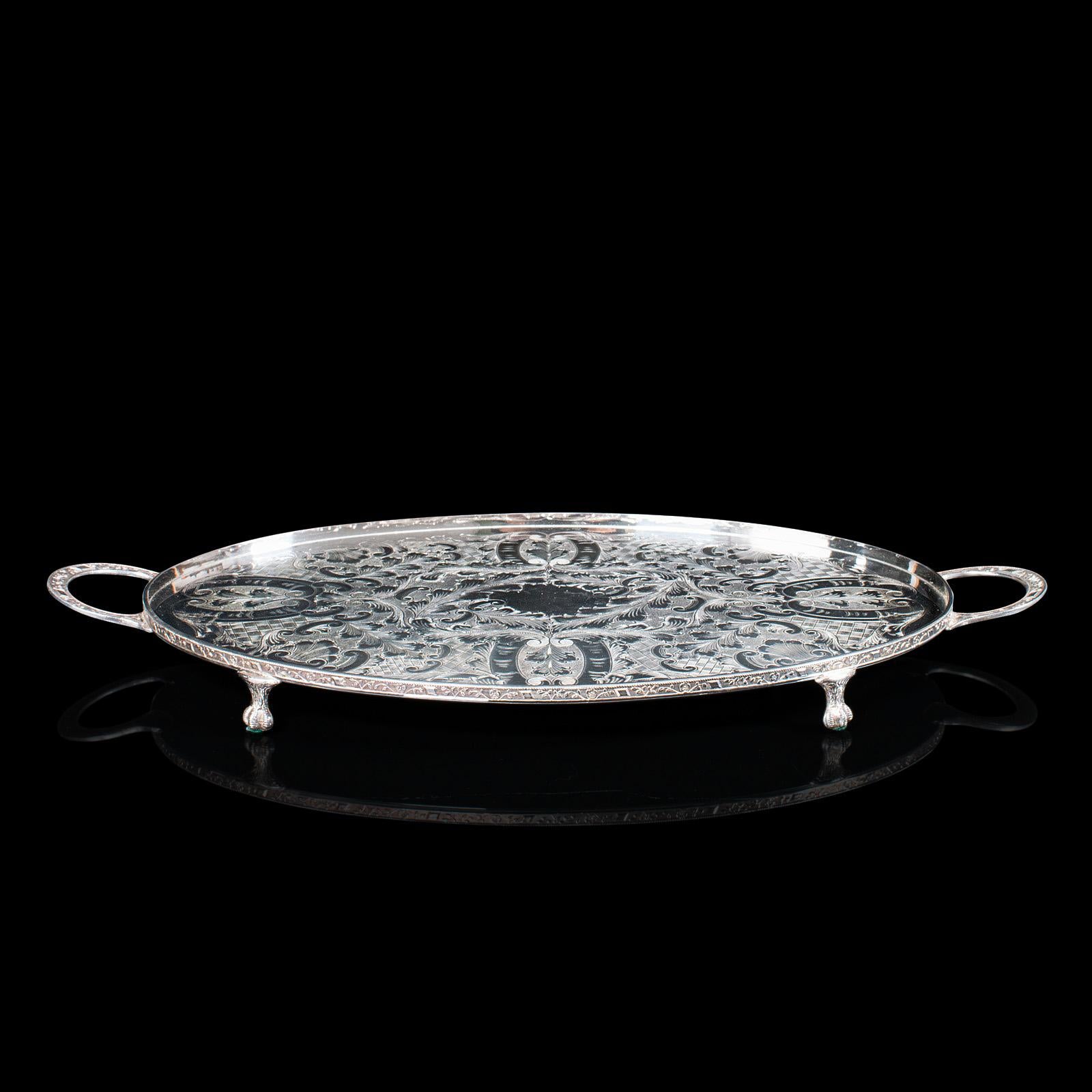 This is a vintage oval serving tray. An English, silver plated afternoon tea platter by Viners of Sheffield, dating to the mid 20th century, circa 1950.

Strikingly detailed and desirably ornate tray
Displaying a desirable aged patina and in good