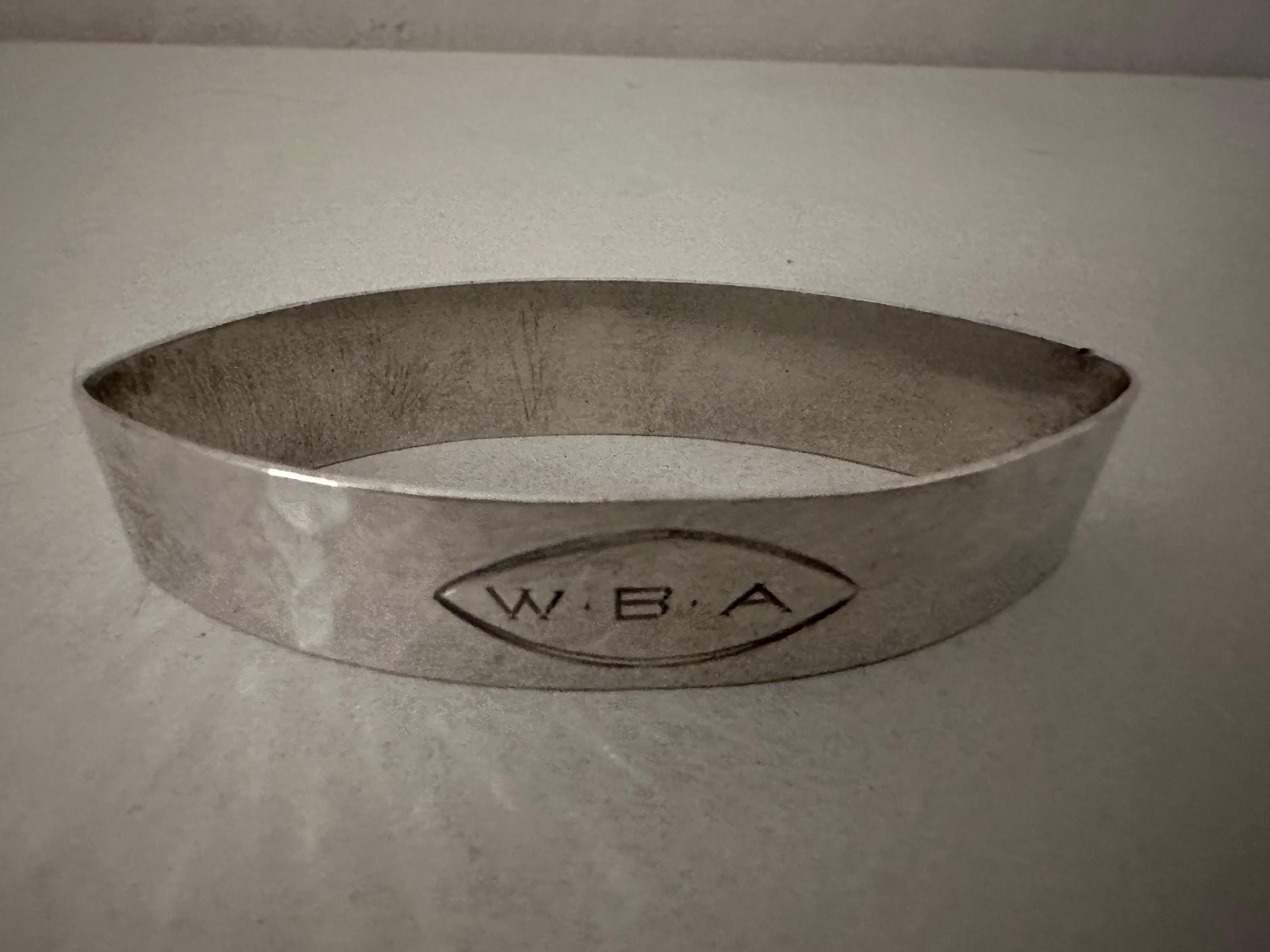 A pointed oval sterling napkin ring with WBA engraved.  Stamped sterling.