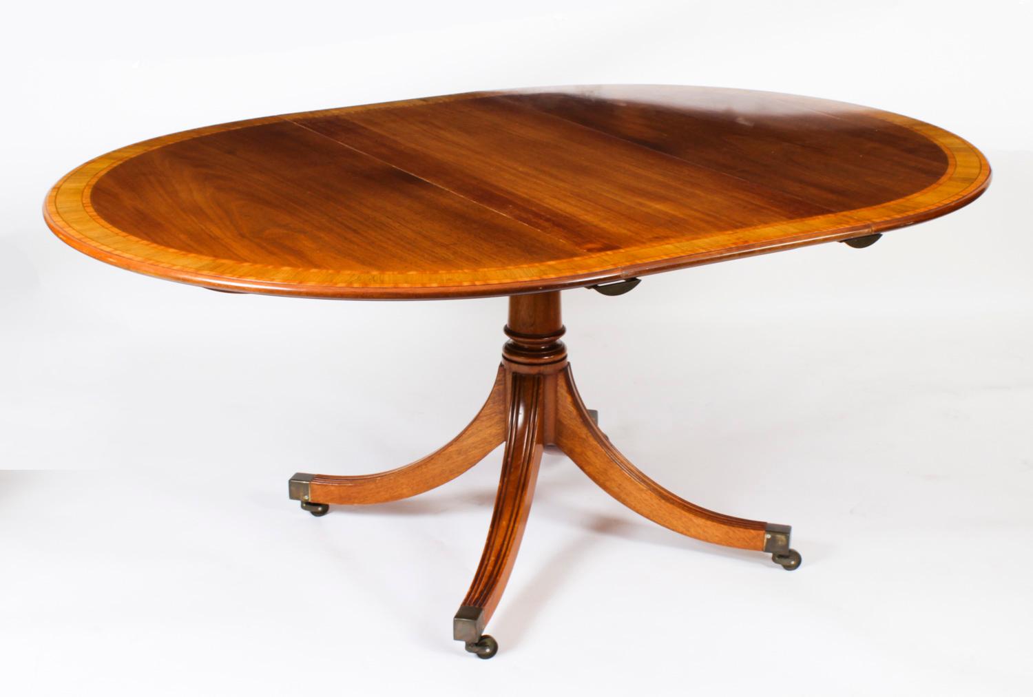 This is a beautiful Regency Revival blond mahogany and Satinwood banded oval dining table with a set ofsix Regency Revival dining chairs, all dating from Circa 1980 made by the Master Cabinet maker William Tillman and bearing his label.

The