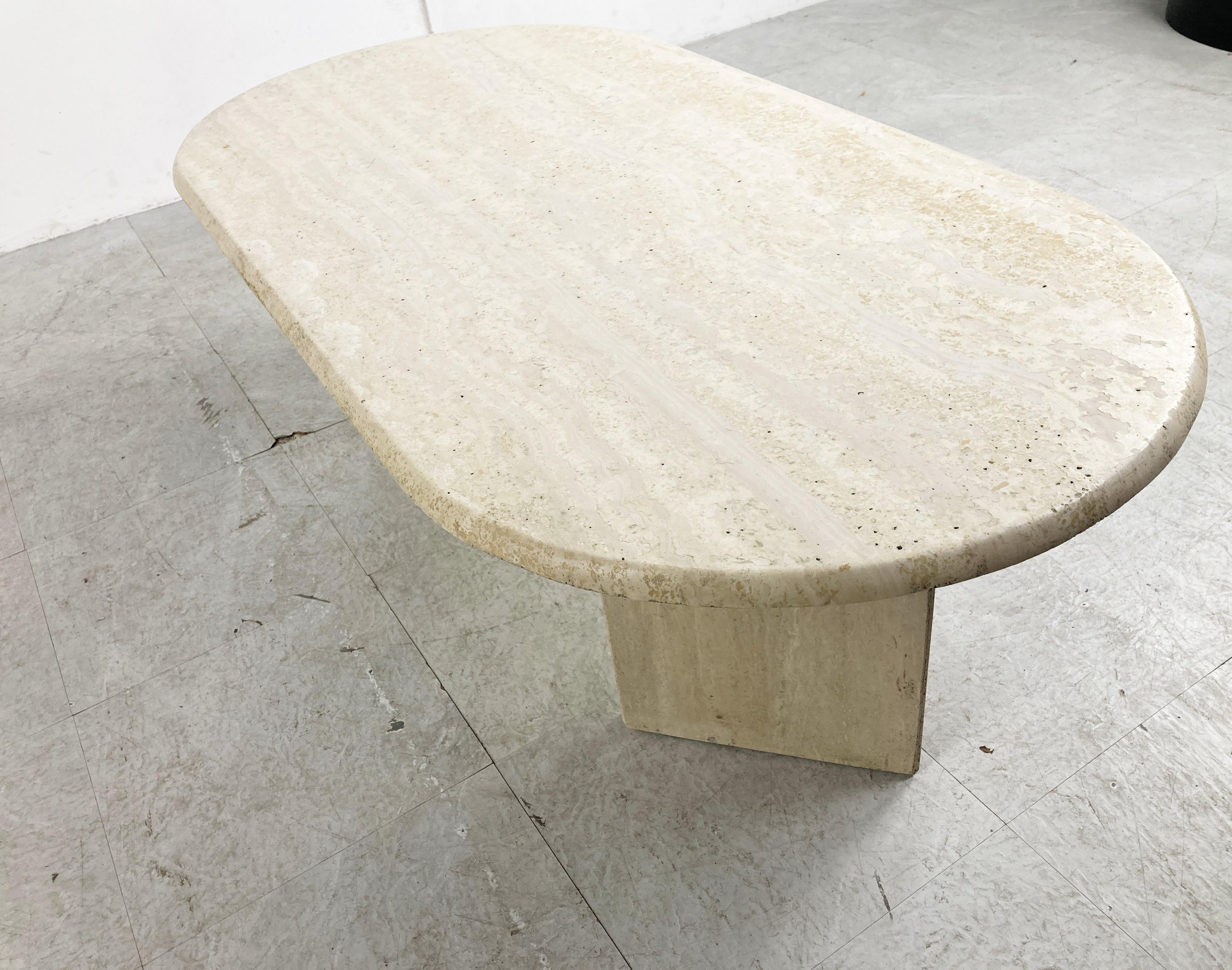 Elegant travertine coffee table with an oval beveled edge table top and two triangular bases.

Timeless piece.

Very good condition.

1970s - Italy

Dimensions
height: 38cm/14.96