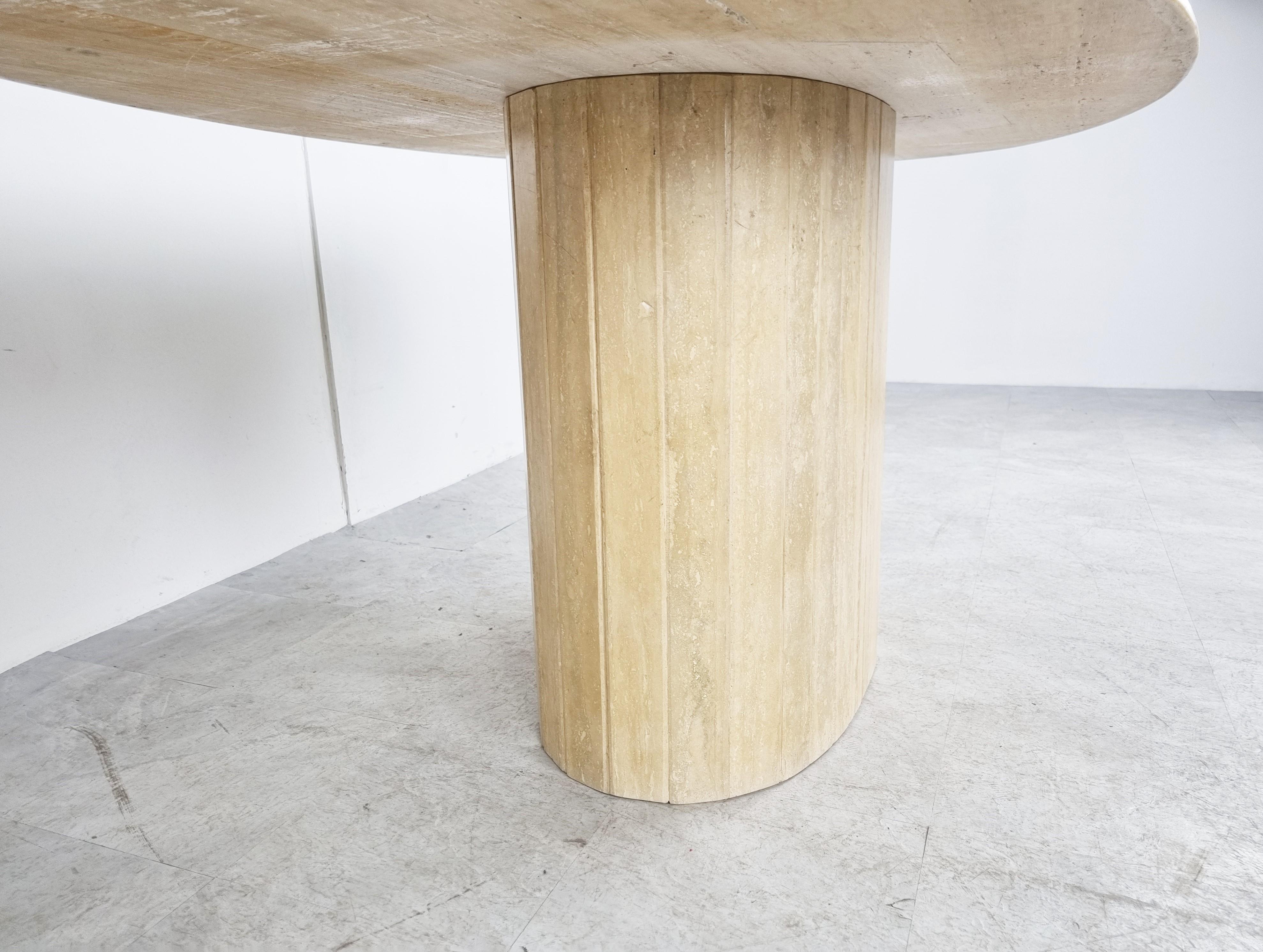Elegant travertine dining table with a reeded central base. 

Beautiful coloured travertine with a stunning pattern.

Timeless and very beautiful table wich fits most interiors.

Good condition. 

1970s - Italy

Dimensions:
Height: