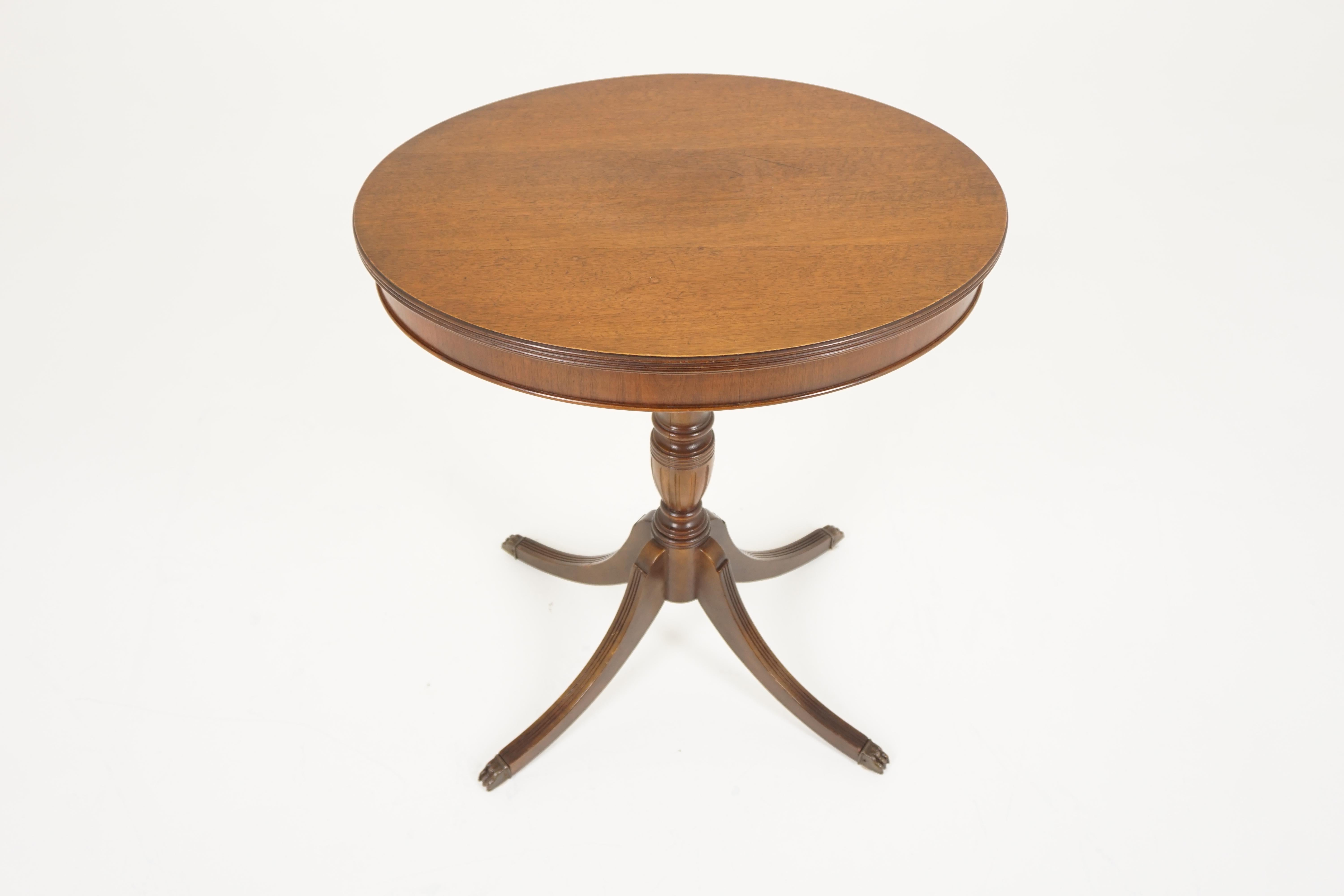 Vintage oval walnut table, Duncan Phyfe, on tripod base, America, 1930s

America, 1930s
Solid walnut
Original finish
Oval top
Standing on a turned pedestal with four swept out, reeded legs with brass caps on the bottom
Nice solid
Good