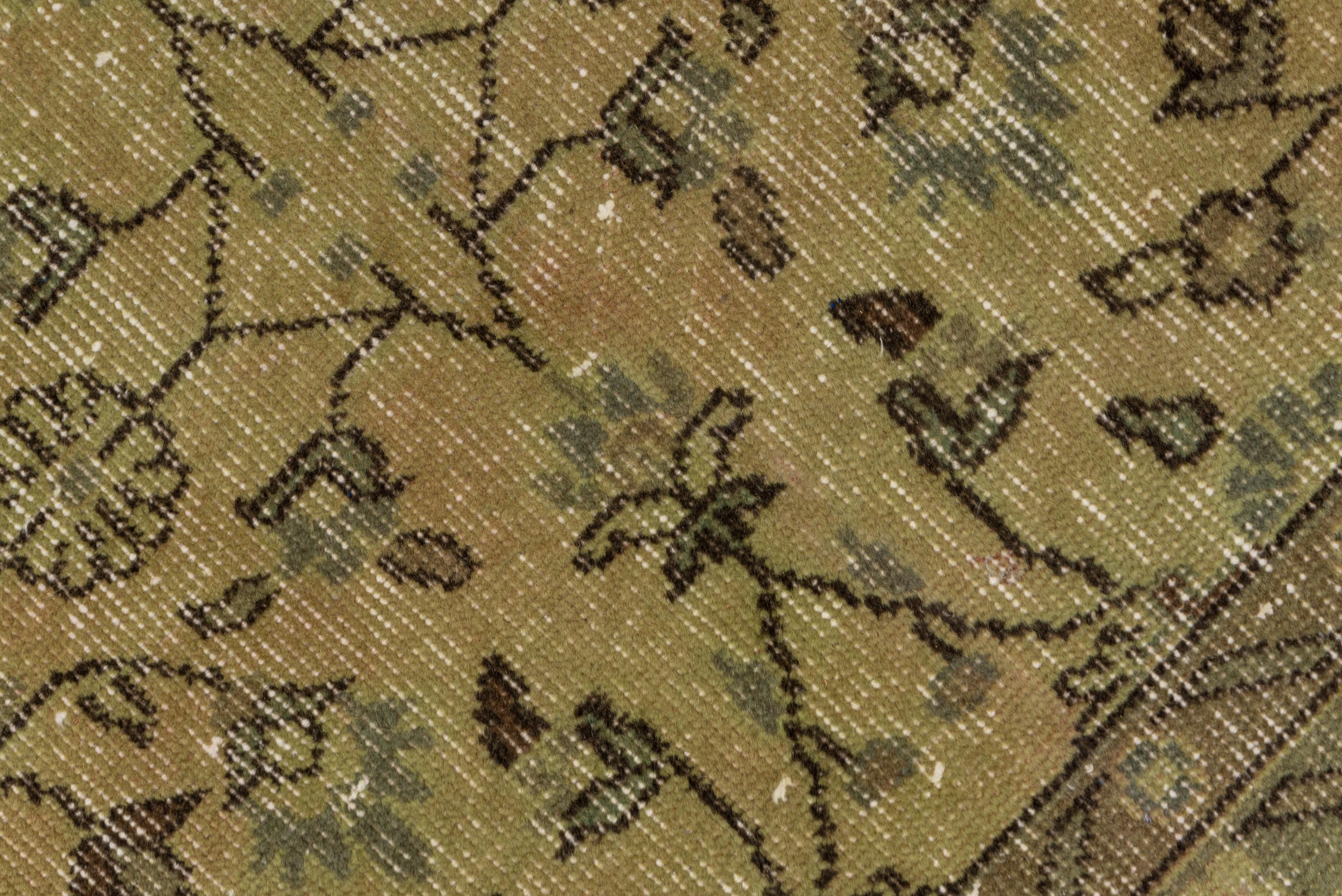 This Turkish Oushak or Sparta in worn condition was overdyed lightly to create a golden all-over tone. The field displays a wiry, repeating pattern of thin stems, rosettes and small blossoms.