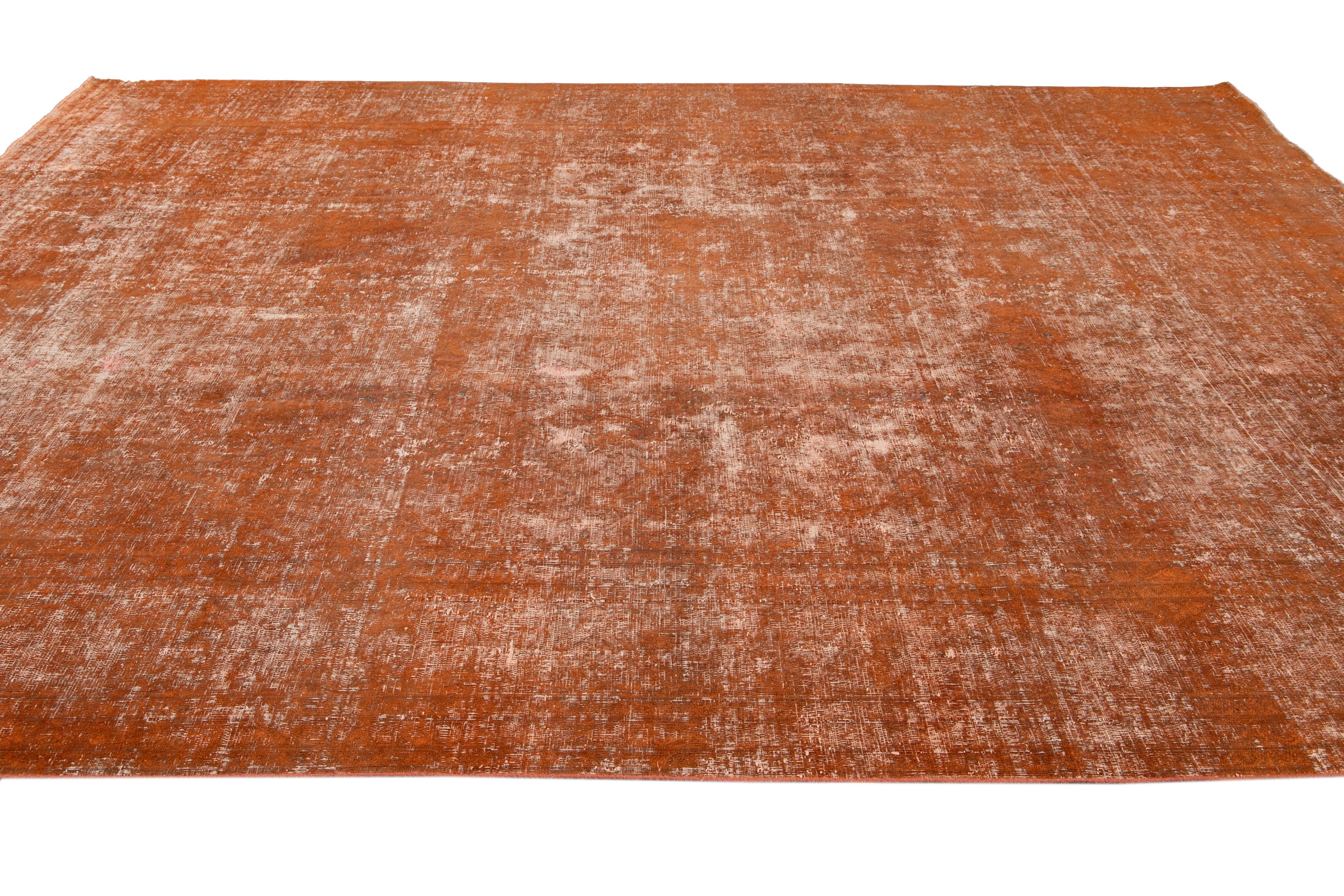 20th Century Vintage Overdyed Orange Room Size Wool Rug. 9'5