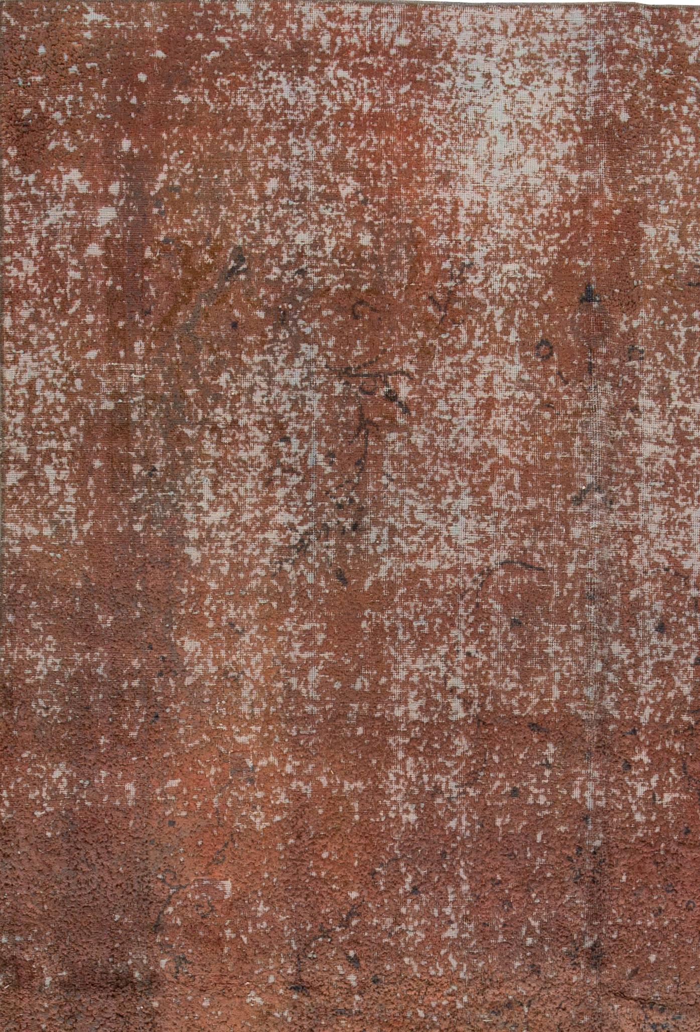 A vintage hand-knotted overdyed distressed rug with an all-over design. This rug measures 6'8