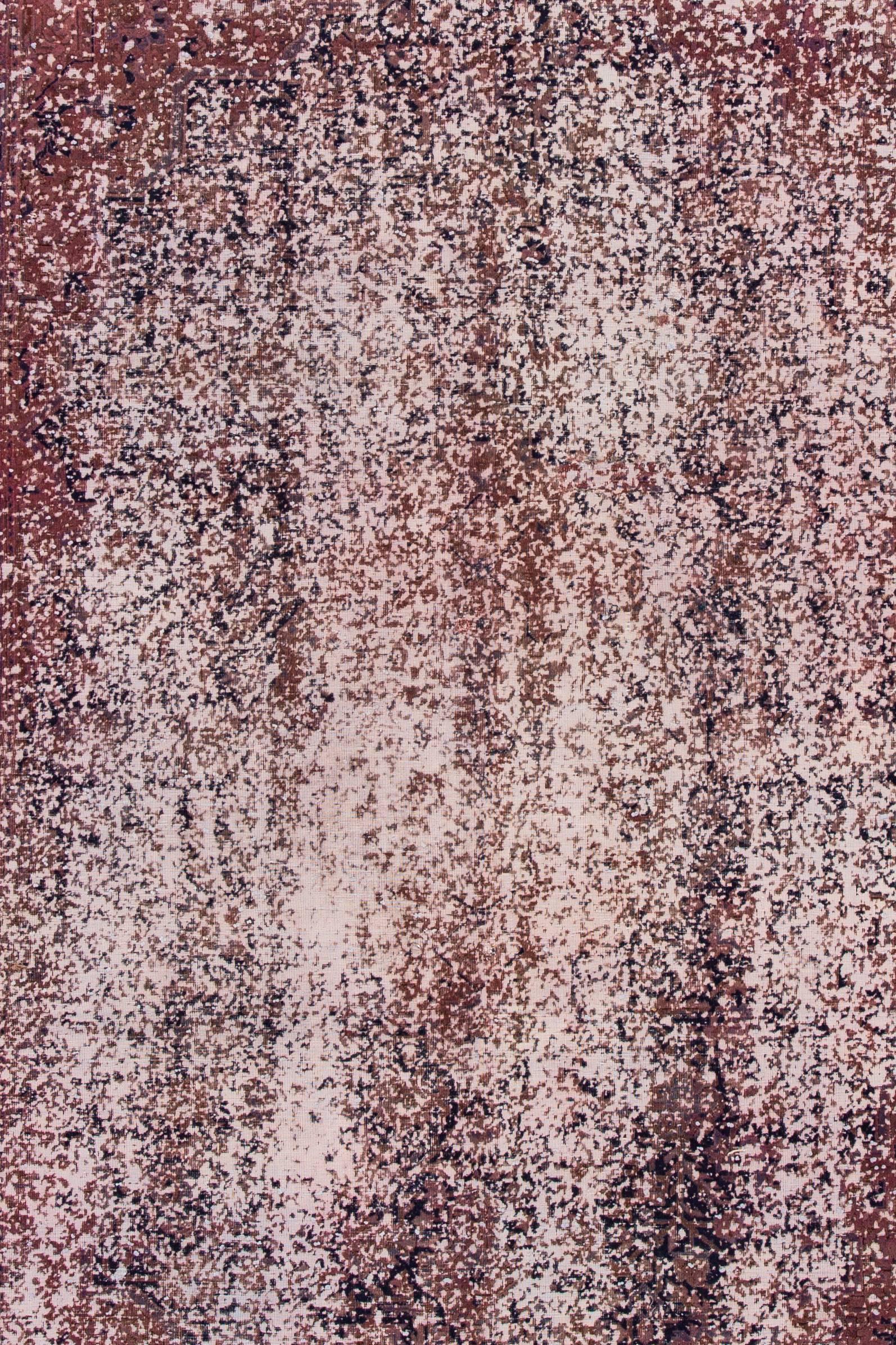 A vintage hand-knotted overdyed distressed rug with an all-over design. This rug measures: 7'3