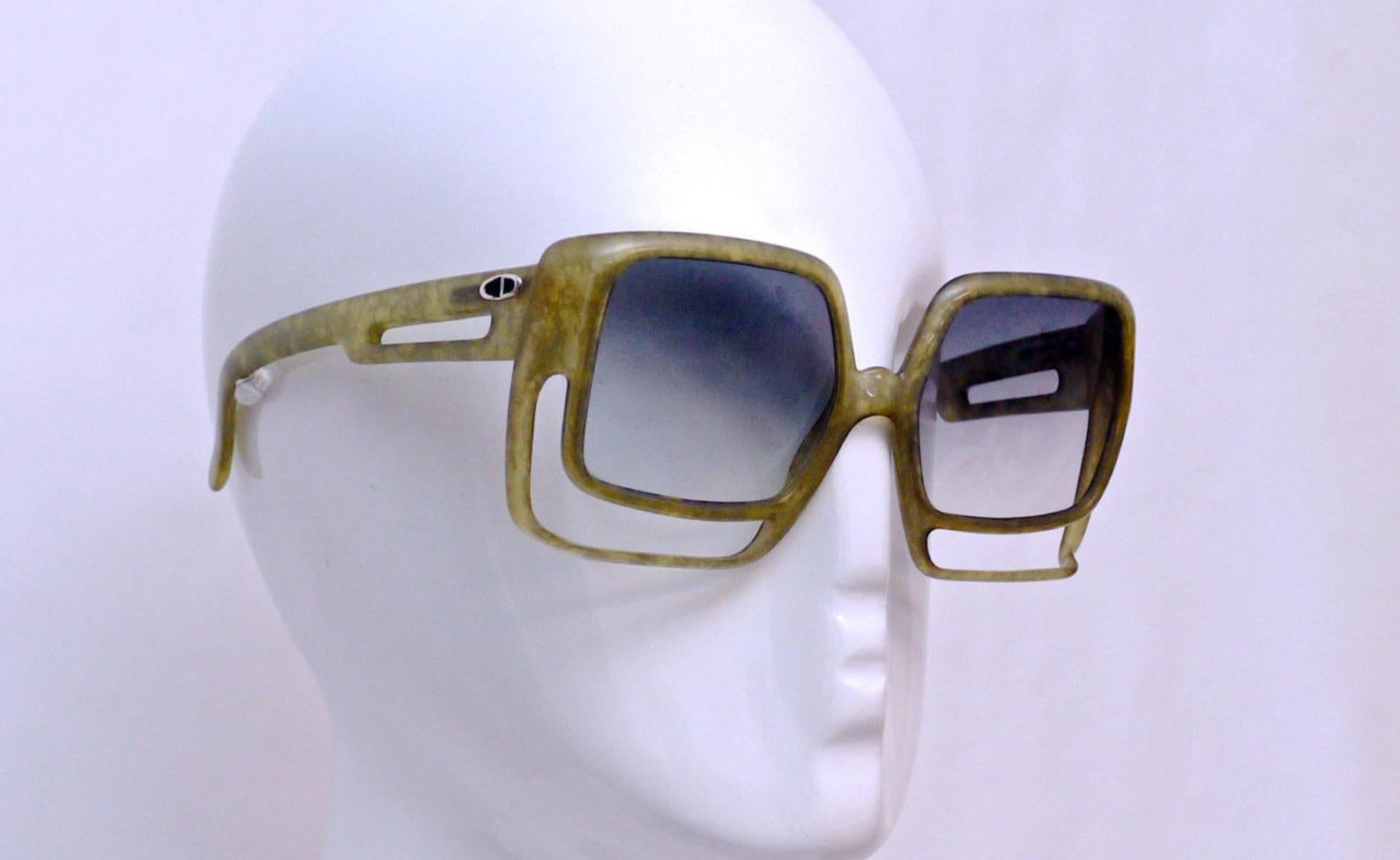 Vintage Oversize Christian Dior Space Age Green Sunglasses

Measurements:
Height: 2 5/8 inches
Horizontal Width: 6 inches
Temples: 5 inches

Features:
- 100% Authentic Vintage CHRISTIAN DIOR.
- Oversized space age sunglasses.
- Marbled olive green