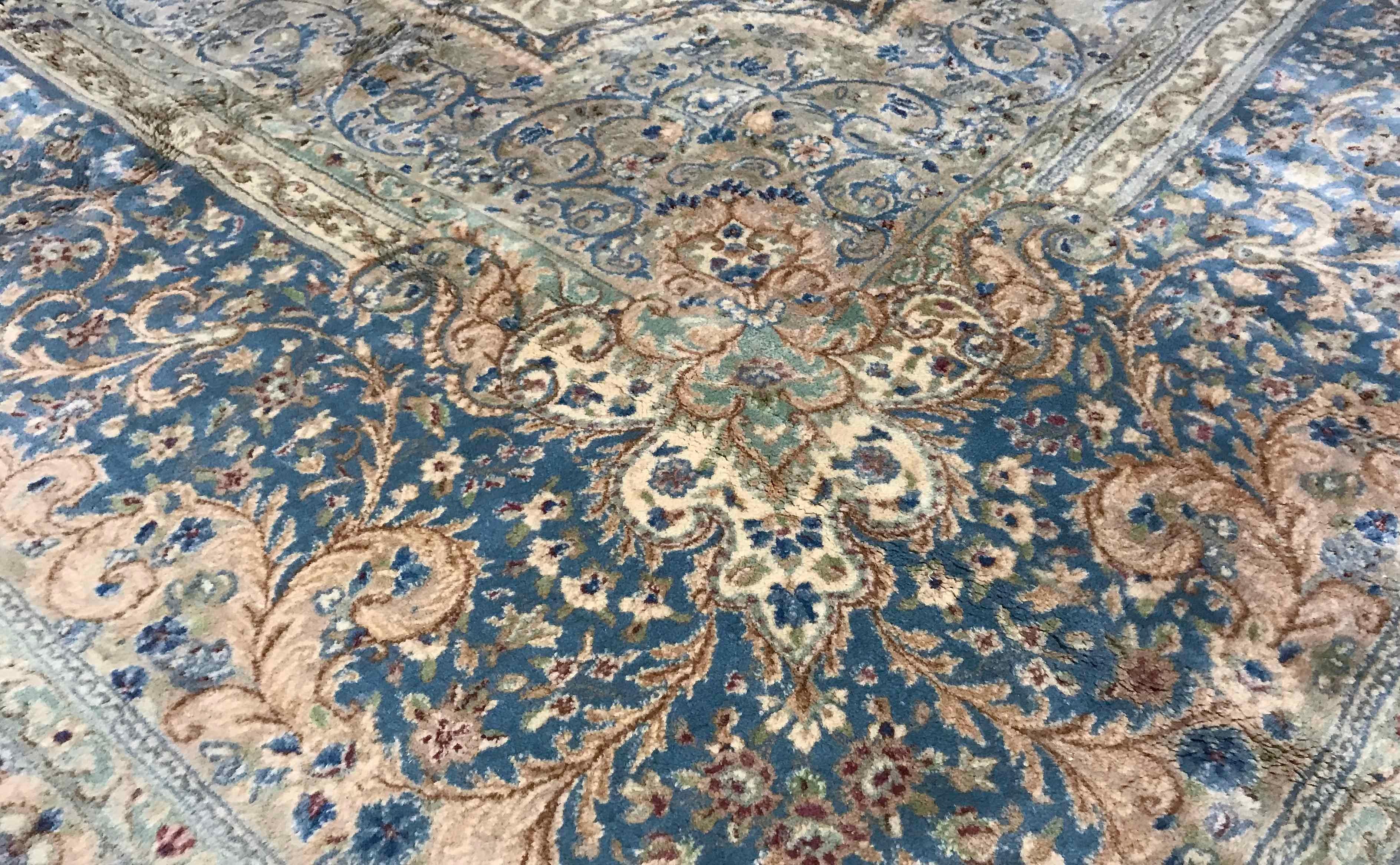Vintage Kerman rug circa 1940. This palace size Kerman rug has a delightful ivory field with a central medallion in soft blues that are repeated in the borders and has created a rug with softness that compliments the size and scale of this piece.
