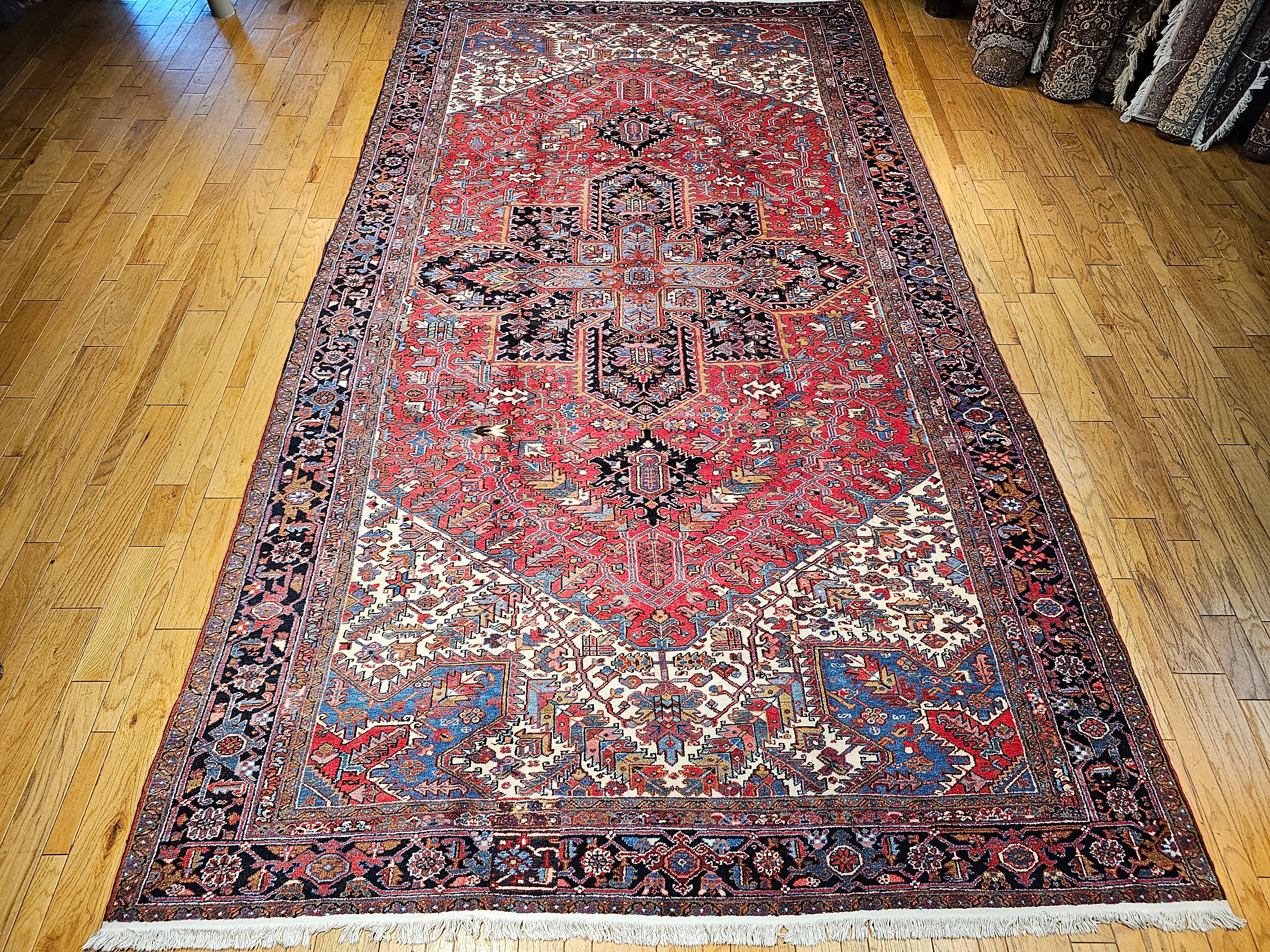 Beautiful oversize rug from Heriz in the Azerbaijan region of Northwest Persia. The Heriz rugs have ageless beauty and because of the use of natural dyes, they develop more beautiful color hues over many generations of use. The use of bright colors