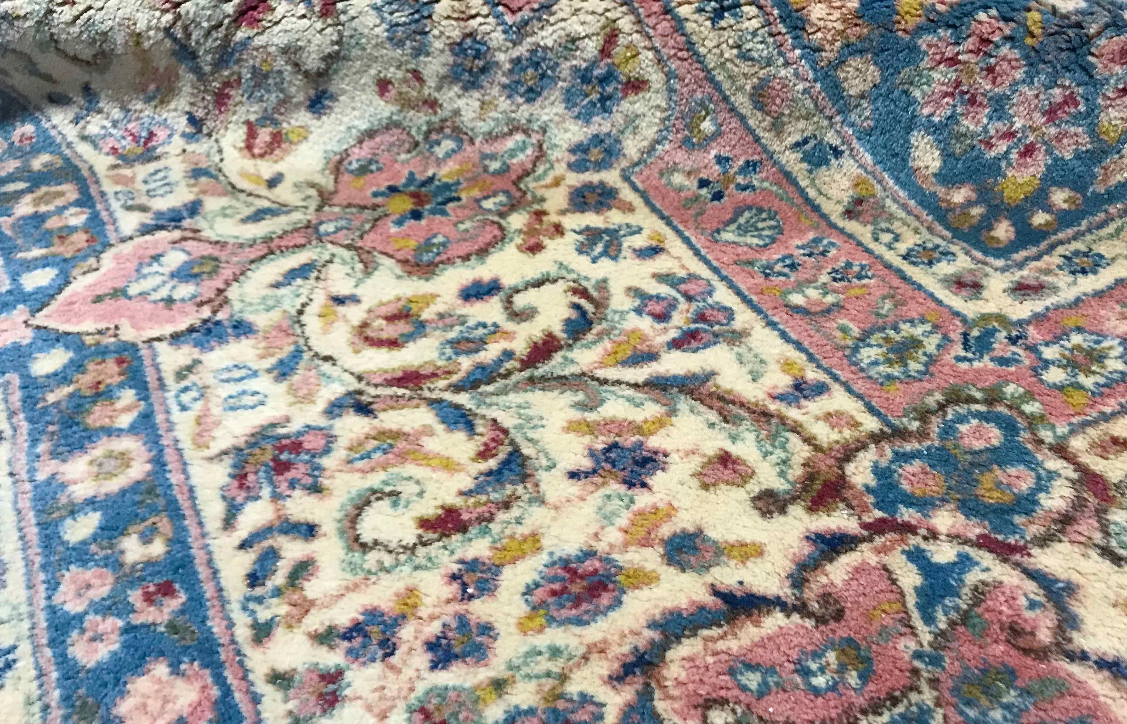 Vintage oversize Persian Kirman Rose / Ivory rug, circa 1940. A rare size for this dramatic Kerman rug the central motif replicated in the borders with a soft powder blue and floral elements is sitting on a deep rose red to create this powerful