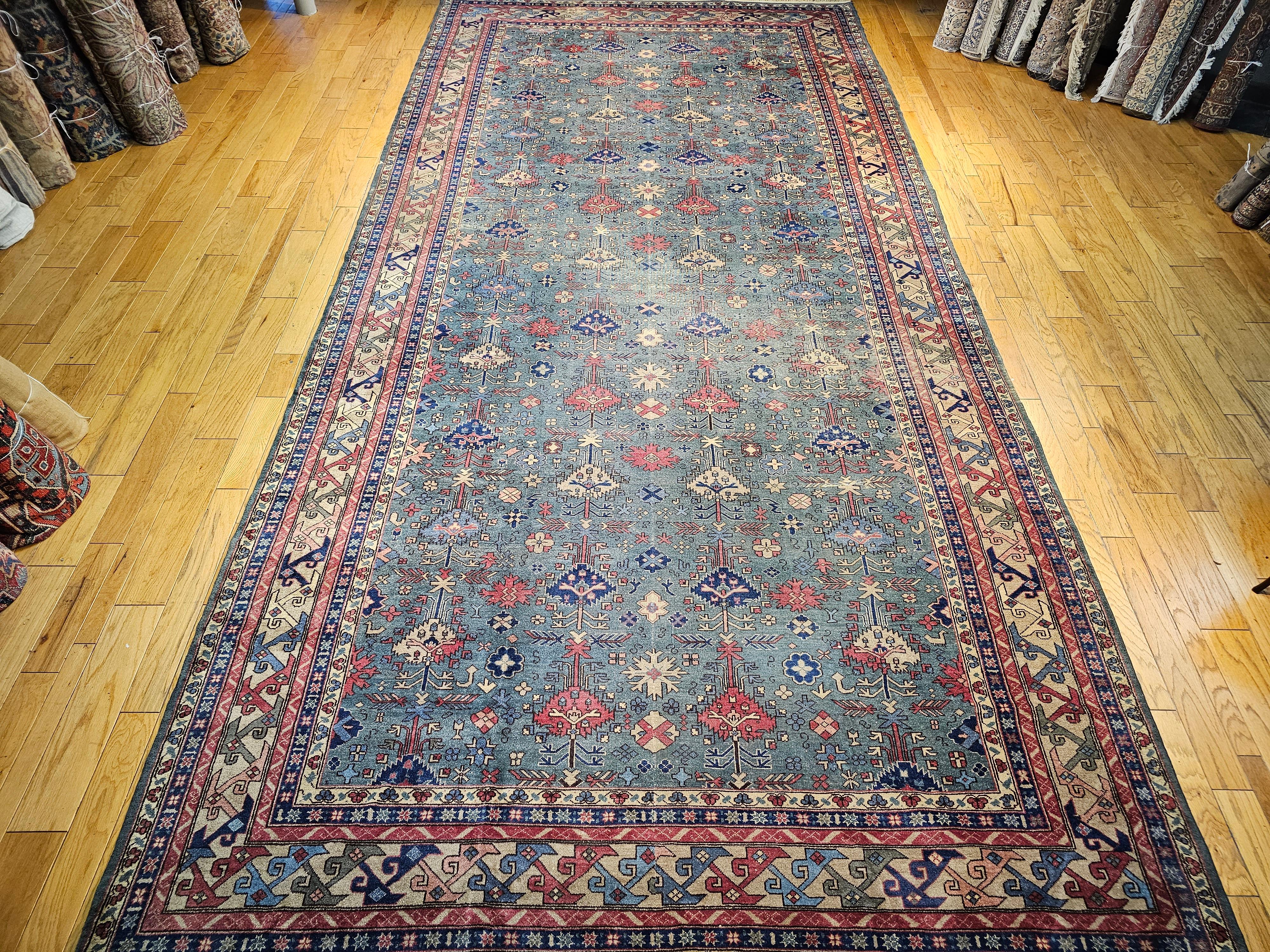 The Turkish Kazak design rug has an all-over geometric pattern that was hand-knotted in the manner of the rugs from the Caucasus in the early 1900s.  The field has a beautiful pale teal color with geometric design shapes in red, green, blue, ivory,