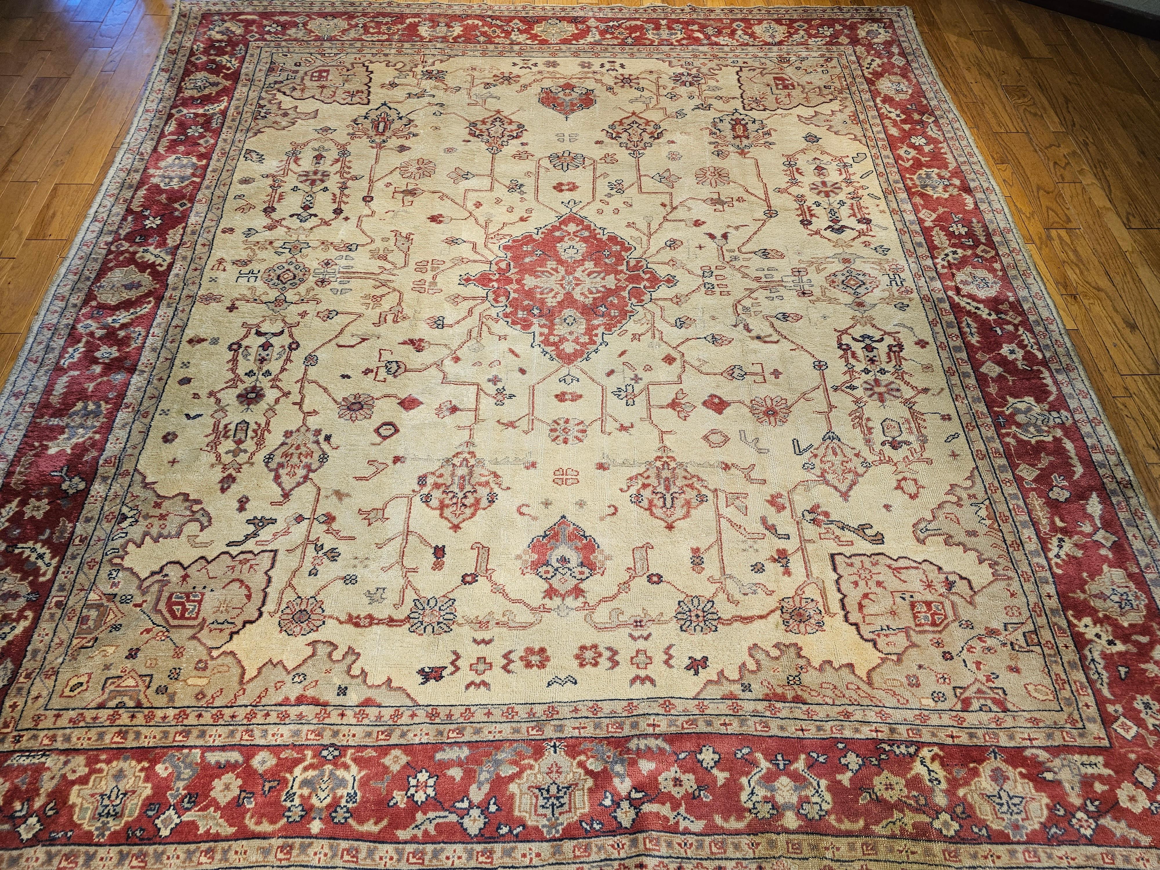 Extremely rare and very desirable Square oversized Turkish Oushak from the early 1900s in soft shades of cream, red, pink, green, and pale yellow colors.  The Oushak rug is in the style of the Persian Serapi rugs from the mid-1800s.  It has an open