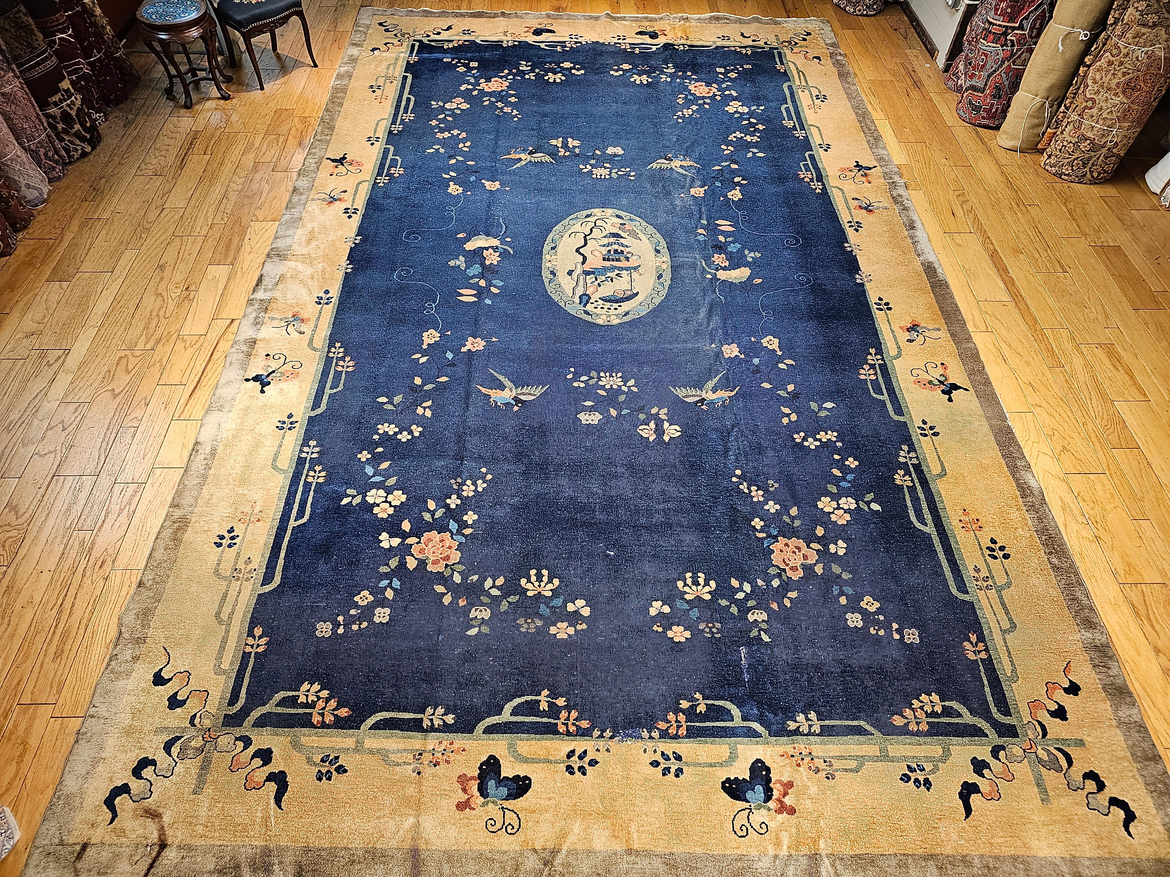 Vintage oversized Chinese Art Deco rug in French blue and tan from the early 20th century.   The rug has a beautiful center medallion, the scene of a pagoda temple and a river that reminds one of a peaceful Japanese meditation garden.  The design