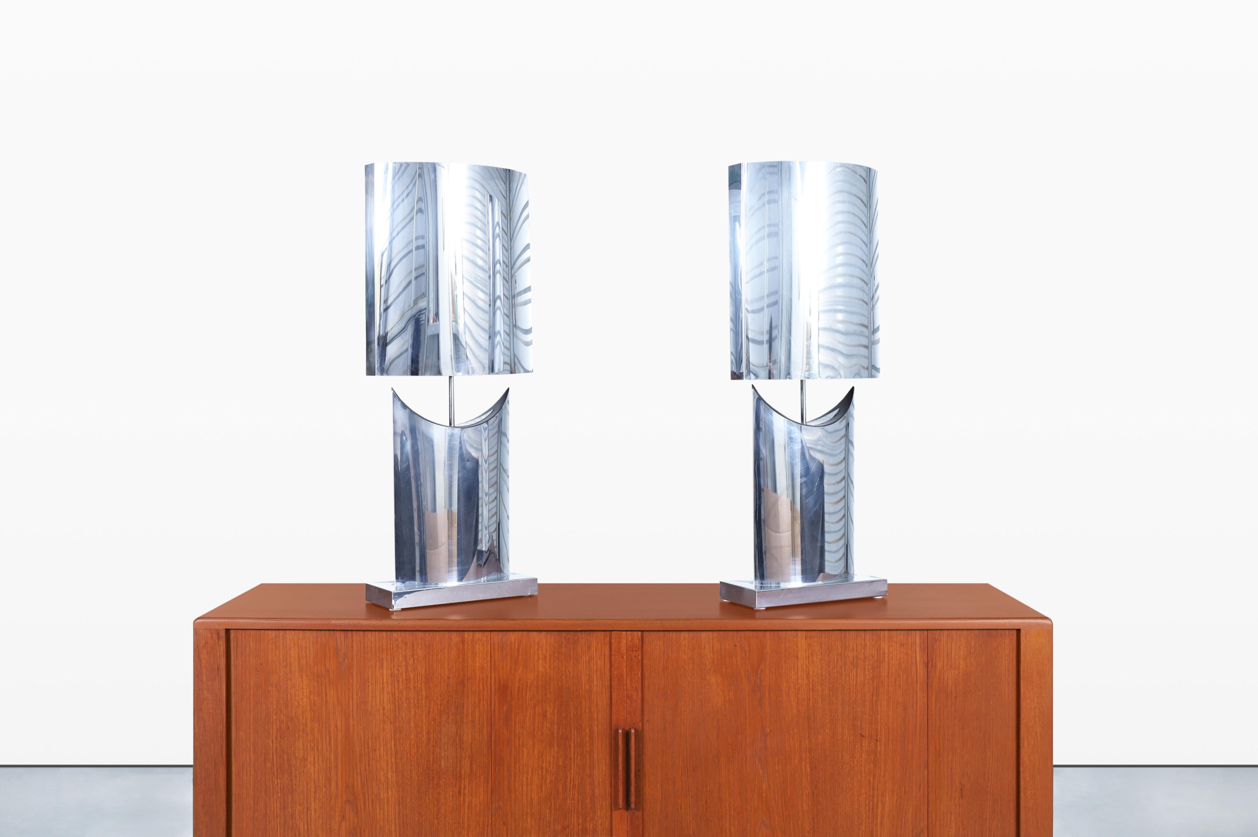 Introducing a stunning pair of vintage chrome lamps designed by the renowned Curtis Jere in the 1970s. These rare lamps are truly special, as they come complete with their original chrome shades, elevating their charm and uniqueness. Standing at an