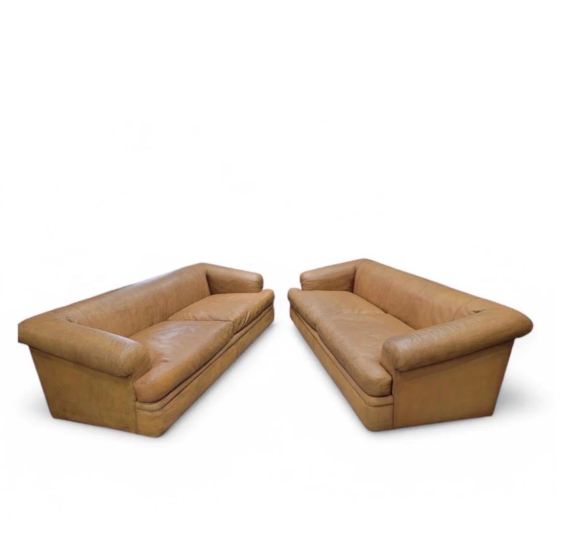 Vintage Oversized Distressed Full Grain Cognac Leather Rolled Arm Sofas by A. Rudin with Custom Pillows - Pair

Vintage Oversized Set Of Deep Down-Filled Full Grain, Naturally Patinated, Distressed Cognac Leather Sofas with Rolled Arms by A. Rudin.