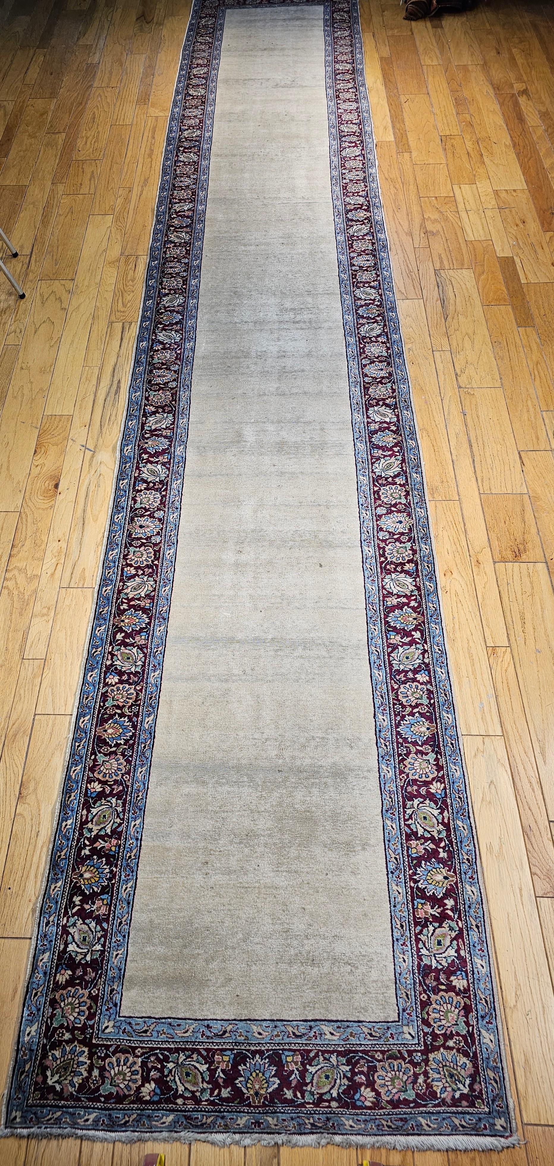 Refined in its simplicity and rare in form, this vintage Persian Khorassan runner rug from the mid-1900s offers an elegant expression of traditional Persian craftsmanship. Hand-knotted in the historic weaving region of Khorassan, this long-format
