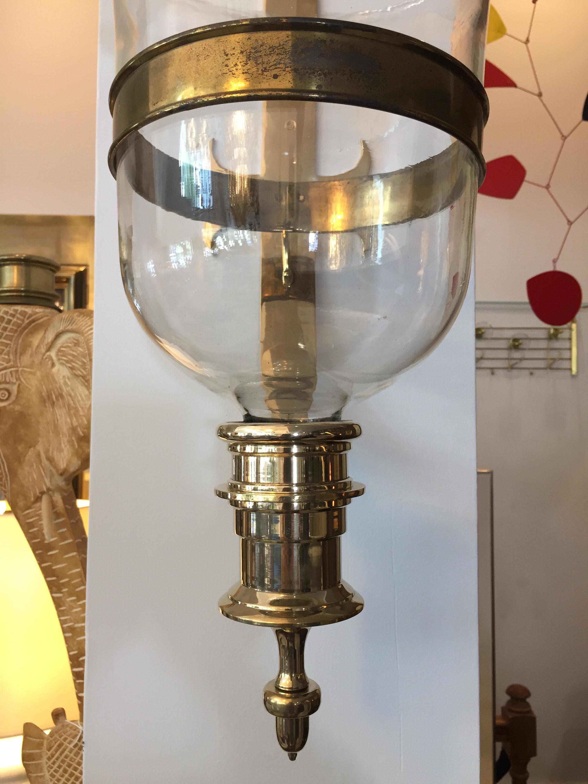 Heavy and important brass wall mounted hurricane lanterns with single socket each and very large original hand blown glass diffusers. This is a pair for the listed price.