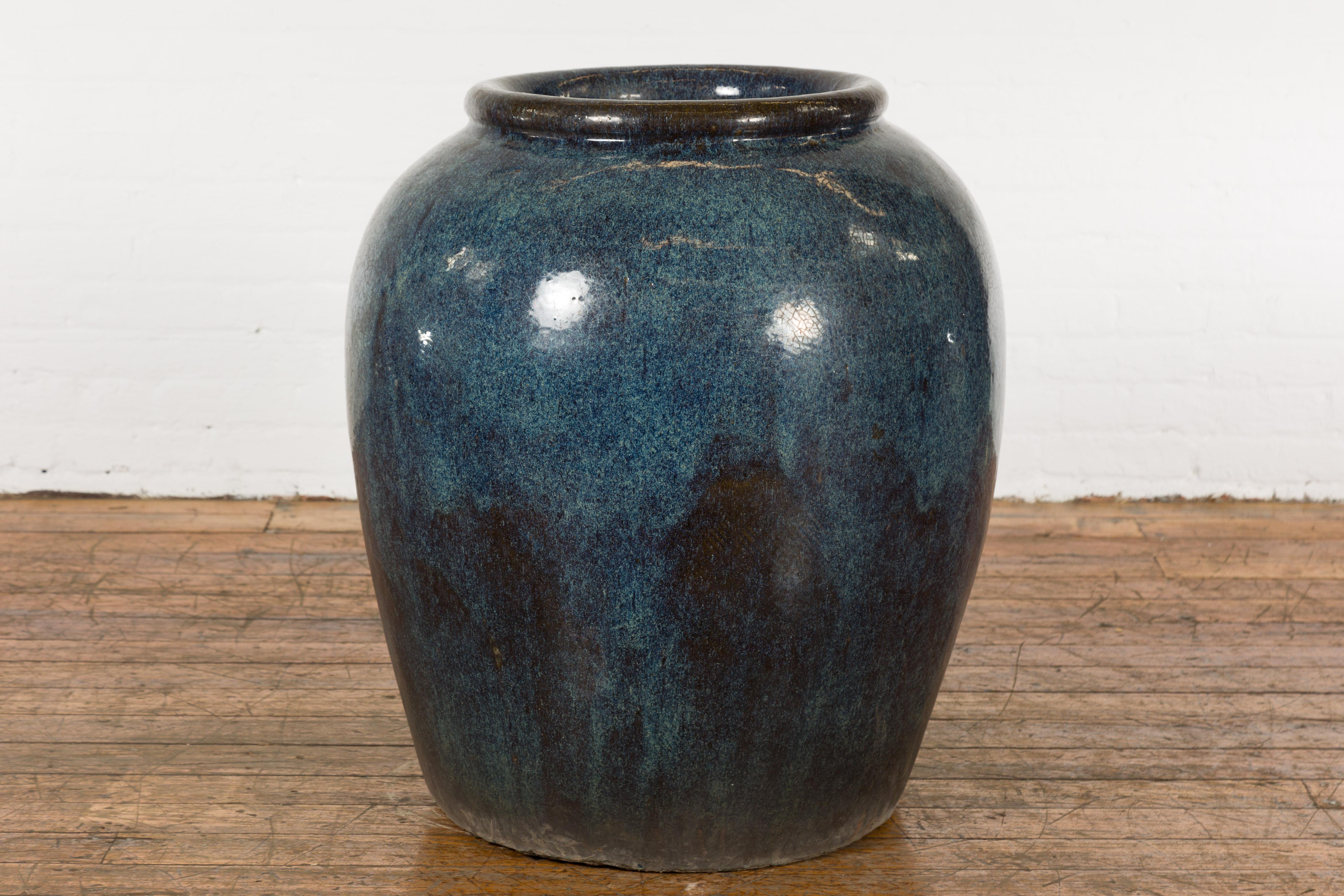 An oversized vintage Japanese Shigaraki style Thai planter from the Mid-20th Century with namako inspired blue glaze. Created in Thailand during the midcentury period, this large Shigaraki style planter features a circular opening measuring 16