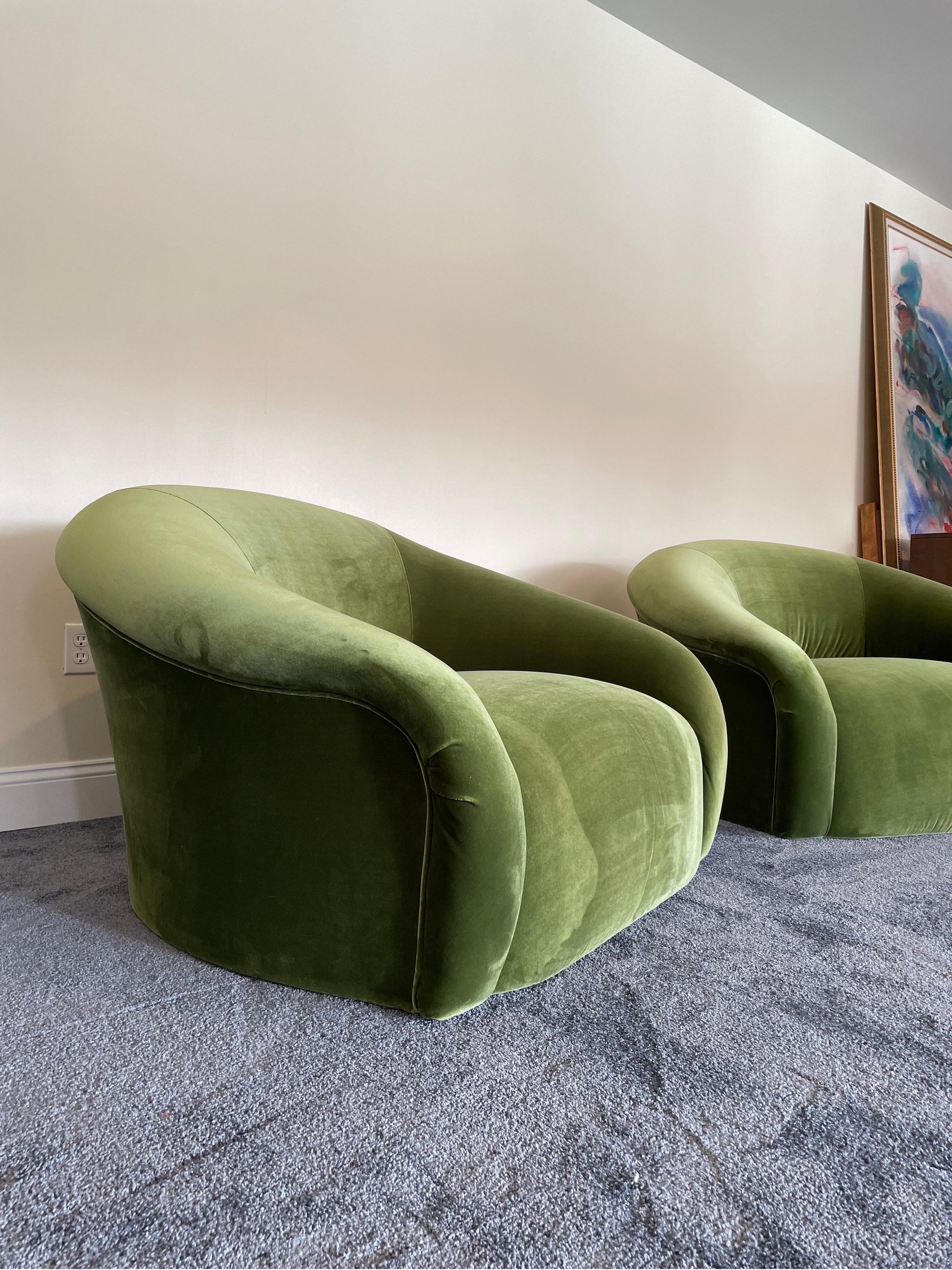 A pair of oversized lounge chairs by Sally Sirkin Lewis for J. Robert Scott beautifully redone in luxurious moss green velvet. Feeling a little Royere, a little Kagan, and a lot comfortable. Chairs are on hidden castors for extra convenience.
