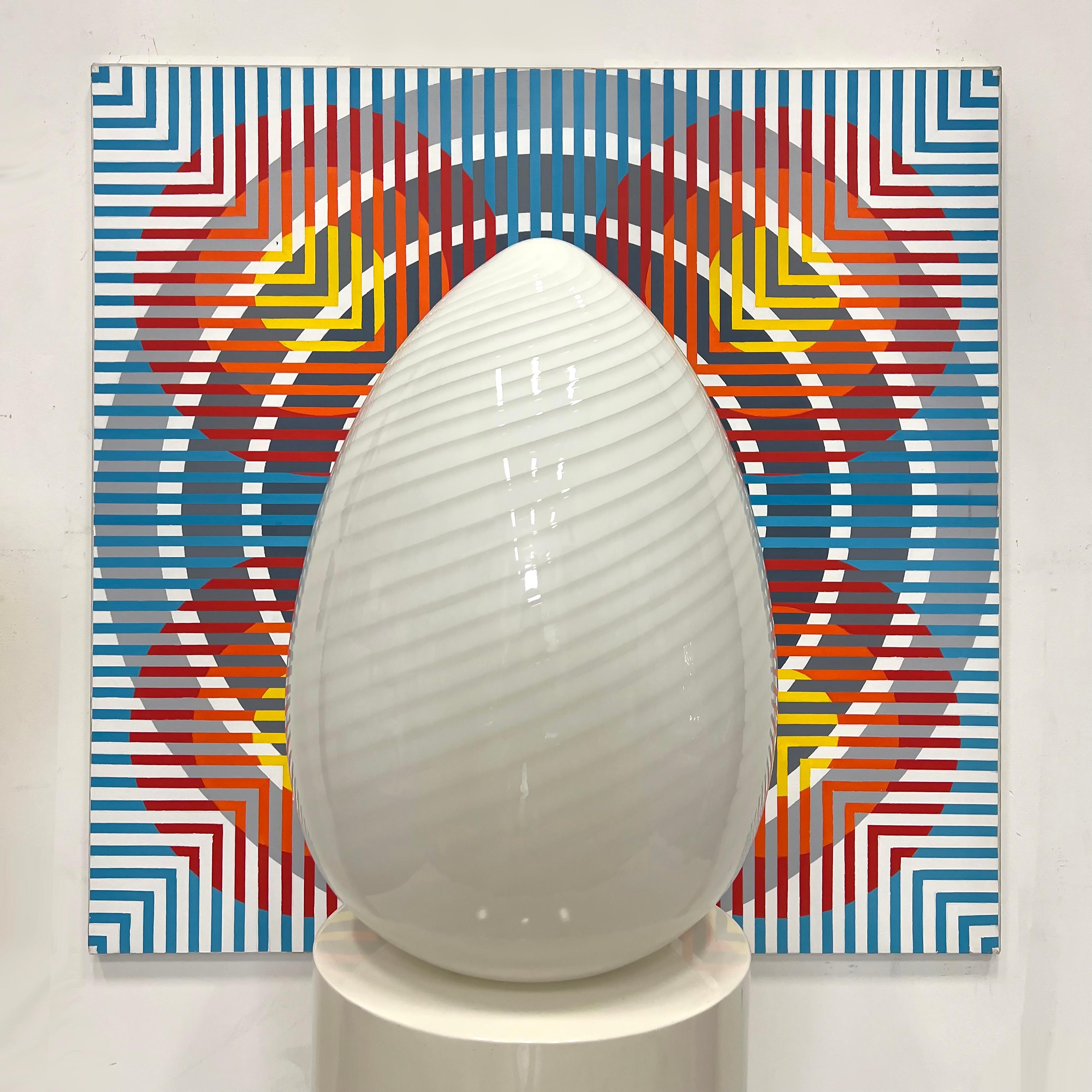 Vintage Oversized Vitri Murano Swirled Egg Table Lamp   

Offered for sale is a vintage oversized Vitri Murano swirled egg lamp. This glass lamp is lit from within by a single standard bulb mounted on the hidden base.  The color of the light can be
