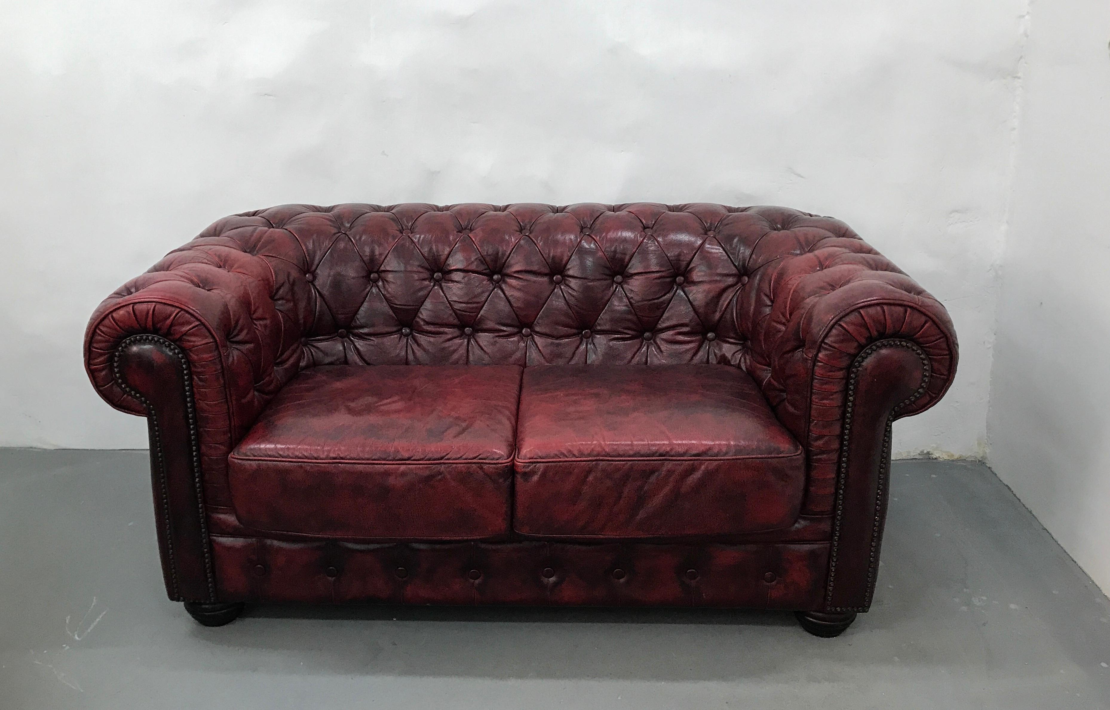 Beautiful 2-seaster original vintage oxblood leather chesterfield sofa by Rubelli from Italy. This sofa is great condition for its age and gets better with time. Legs are wooden, round. Color: red brick.
Age: Second half of the 20th century.
   
