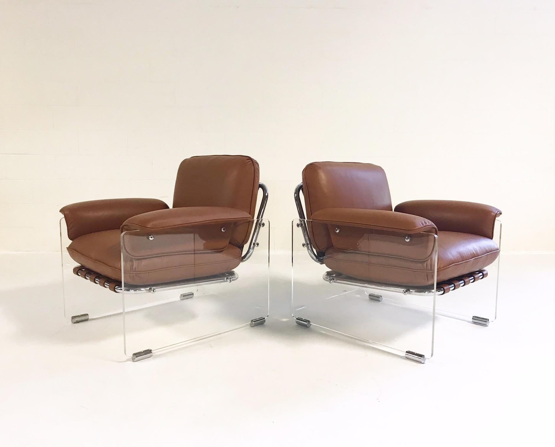 These amazing 1970s Pace Collection lounge chairs feature thick Lucite panels with chrome details. Leather straps wrap the tubular chrome frame to support the cushions. The loose cushions and straps have all been masterfully created and upholstered