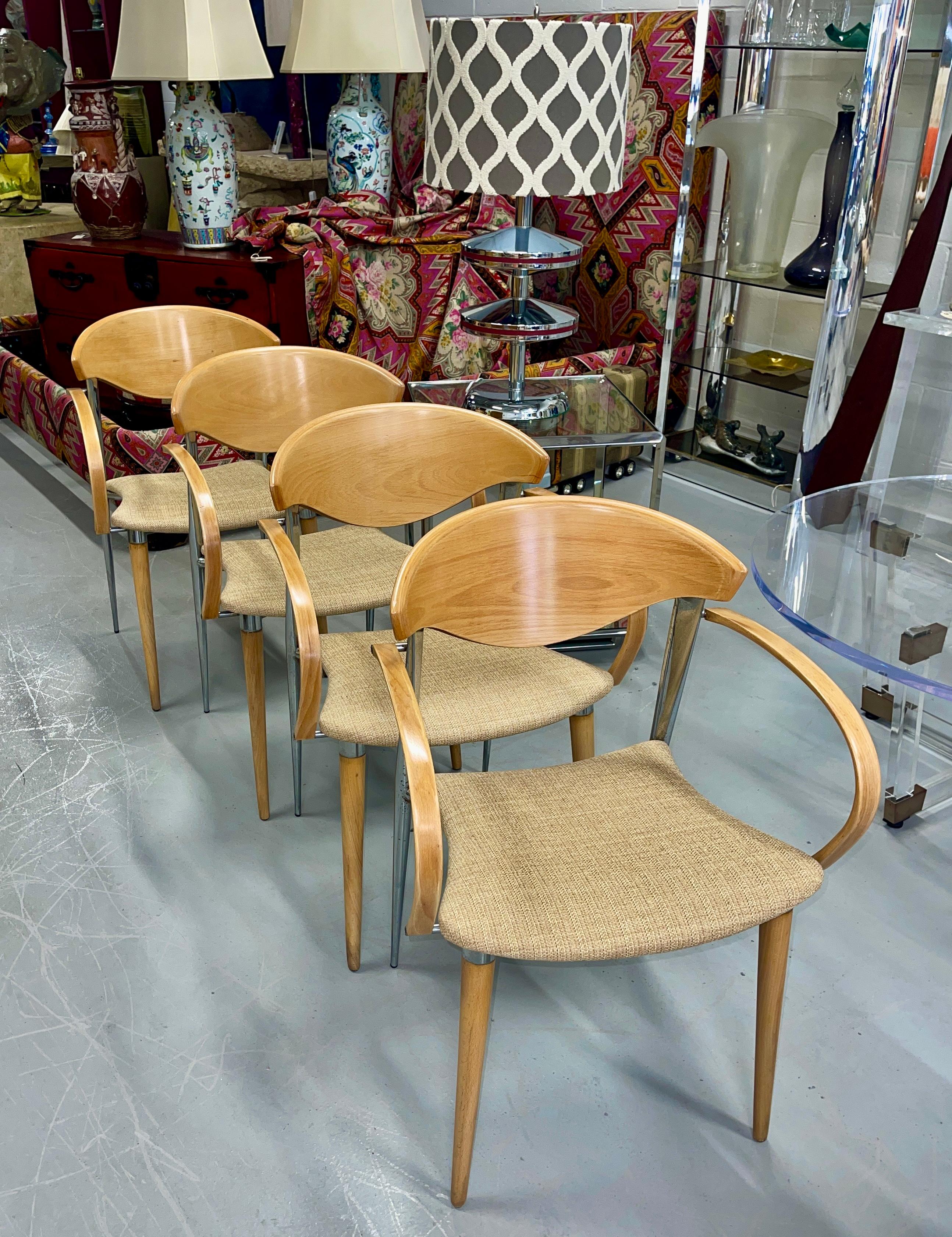 A lovely set of 4 armchairs out of Palm Springs estate. These were used as dining chairs and as desk chairs. Marked on the bottoms Paco Capdell, these chairs are from the Spanish company and likely date to the 1980's. Crafted out of steel and wood,