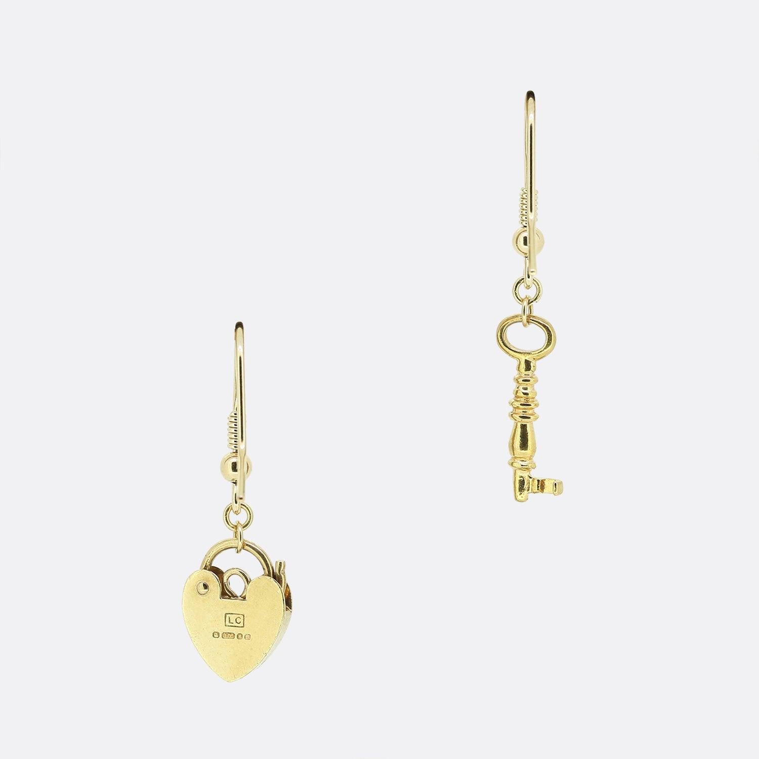 This is a pair of vintage 9ct yellow gold drop earrings. One earring features a padlock charm and the other features a key charm that both sit at the bottom of the fancy chain.

Condition: Used (Very Good)
Total Weight: 2.3 grams
Earring Dimensions: