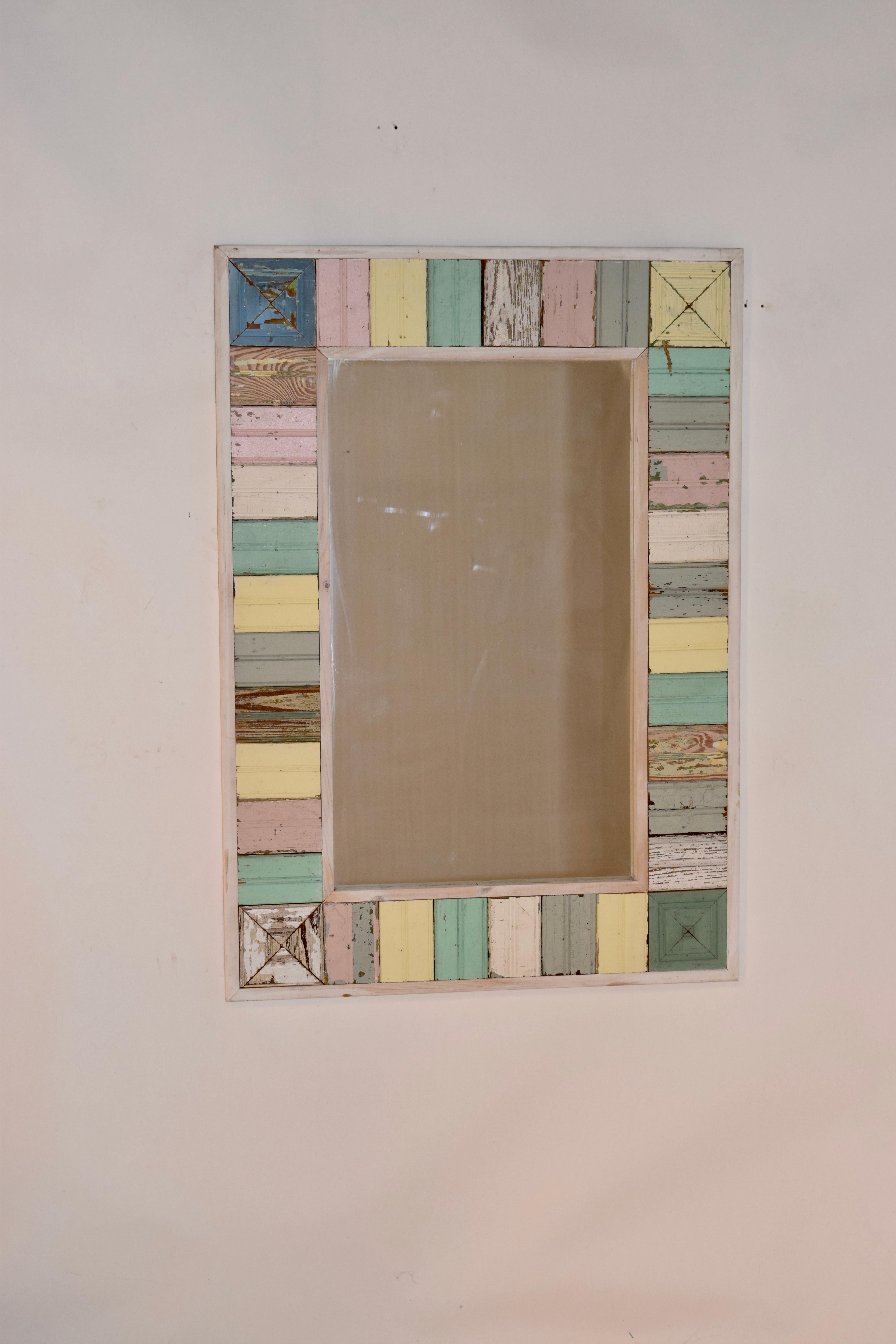 Vintage mirror made from pieces of vintage bead board with original paint finish. The frame was built later to accommodate the barn wood. Plate glass mirror.