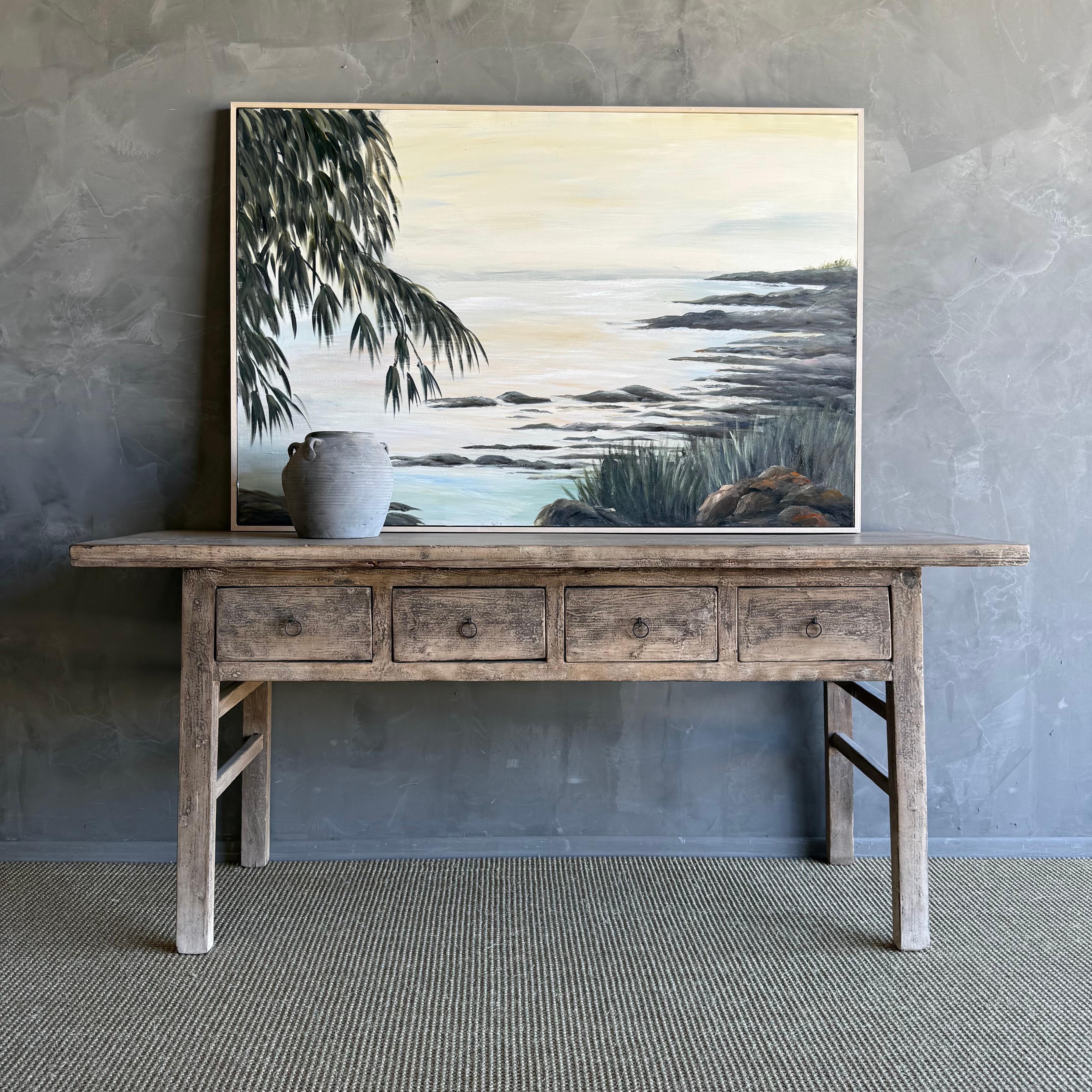 This charming vintage elm wood console is a one-of-a-kind piece with beautiful age and patina that adds character to any space. Its patina painted elm wood finish showcases the natural beauty of the wood, while the solid elm wood original hardware