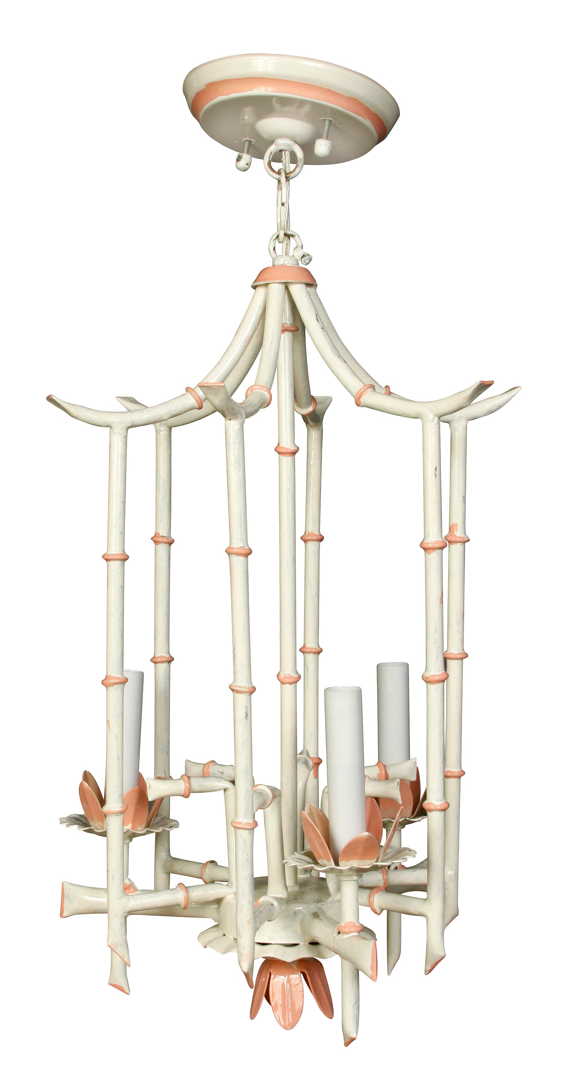 Charming vintage faux bamboo chandelier, painted white with pink coral accents.