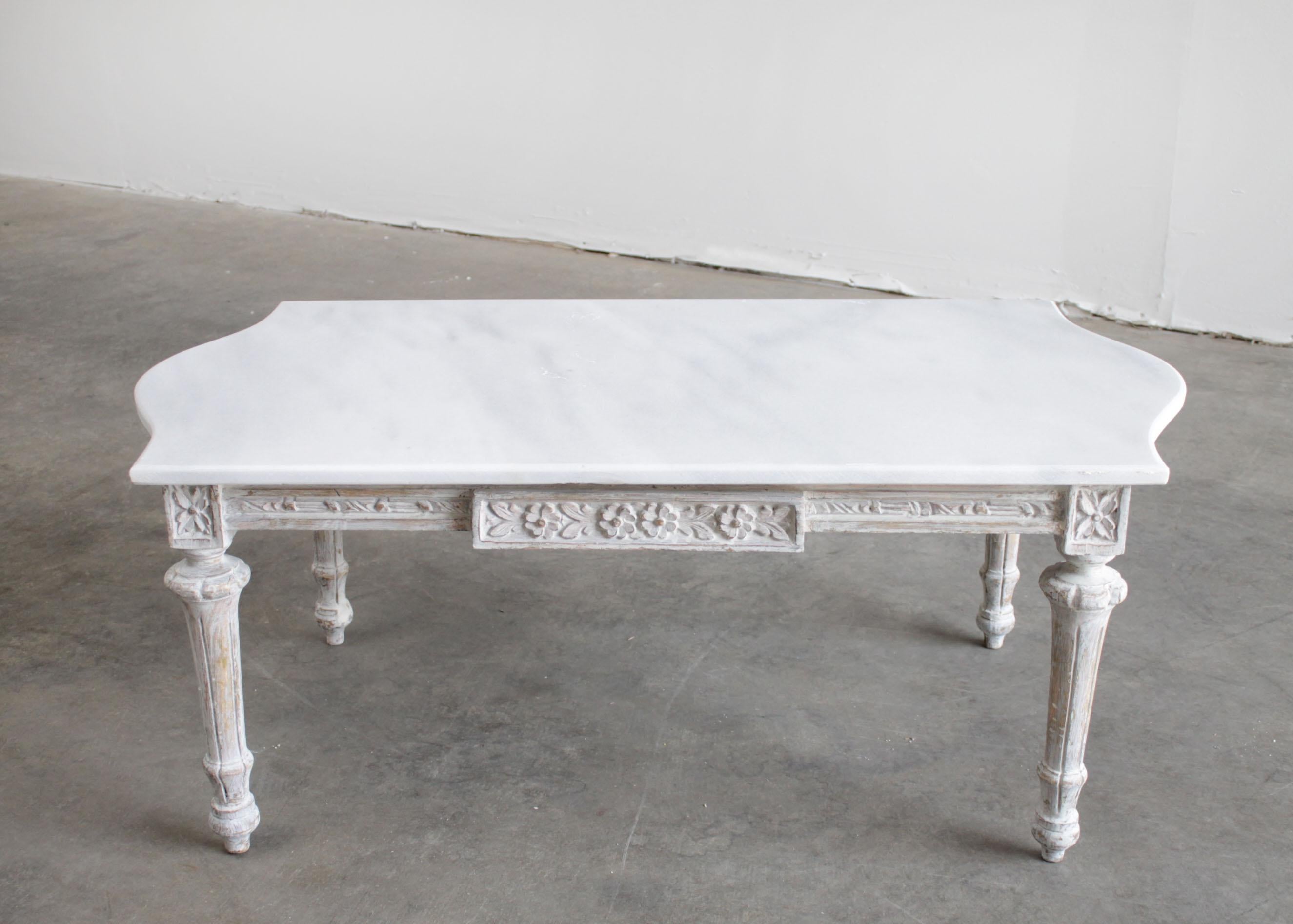 Vintage painted French Louis XVI style coffee table with marble top
Painted in a soft oyster finish, which is a grayish-white with subtle antique distressed edges.
Marble top shows signs of subtle scuffs or scratches, this is standard for all