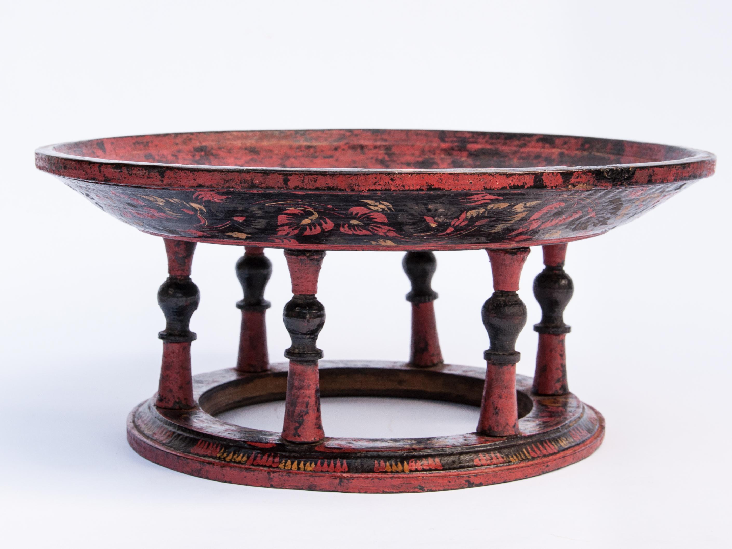 Vintage painted lacquer teak wood tray on stand, Daung-lan. Shan of Burma. Early to Mid-20th century.
This red and black decorated tray comes from the Shan State of Eastern Burma, and was used to serve food; dishes were placed on the tray to be