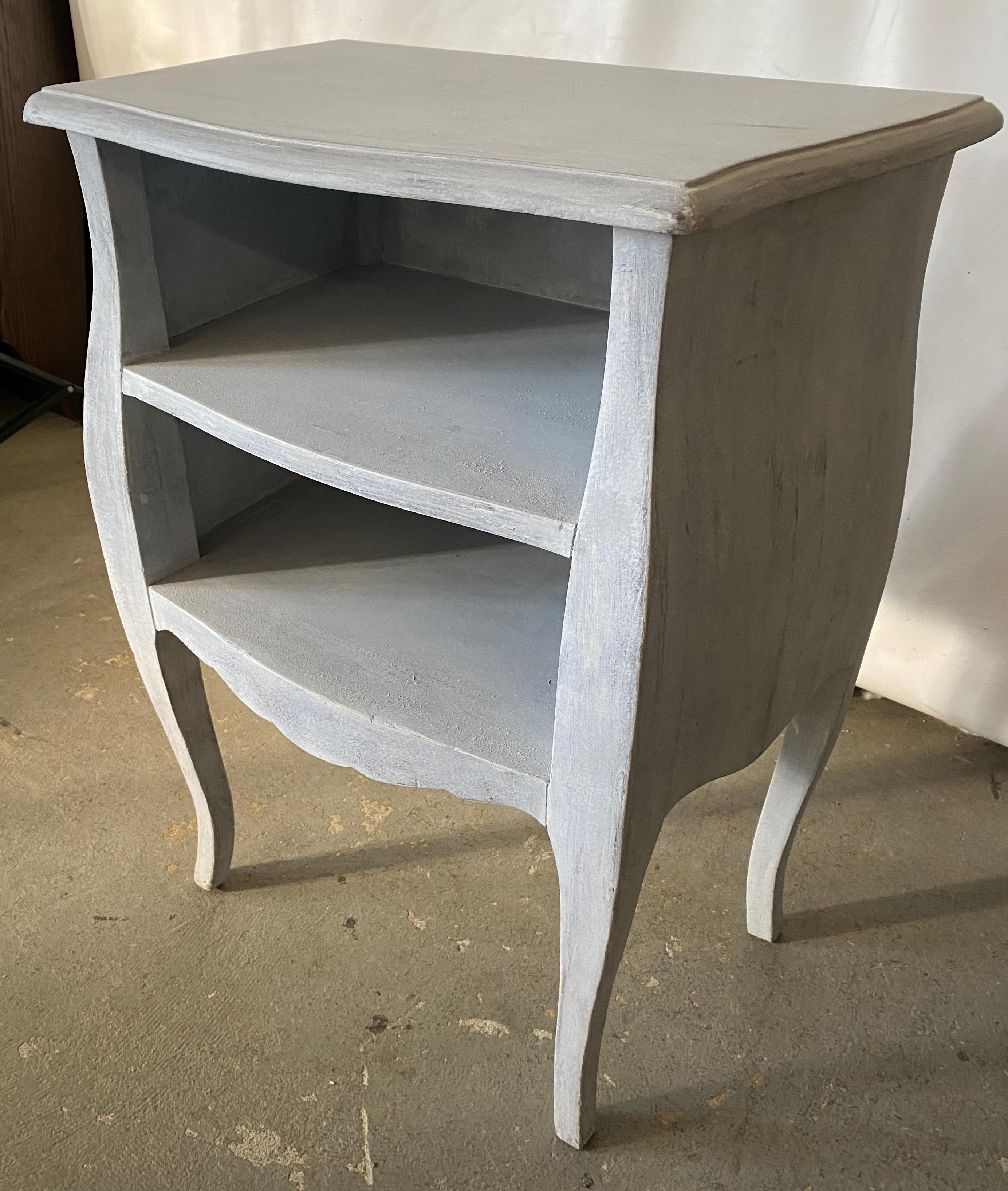The French Provincial style painted grey nightstand has two open shelves for storage. This night table or stand will fill the bill if you are searching for a Swedish Gustavian, neoclassical or classical design.
  