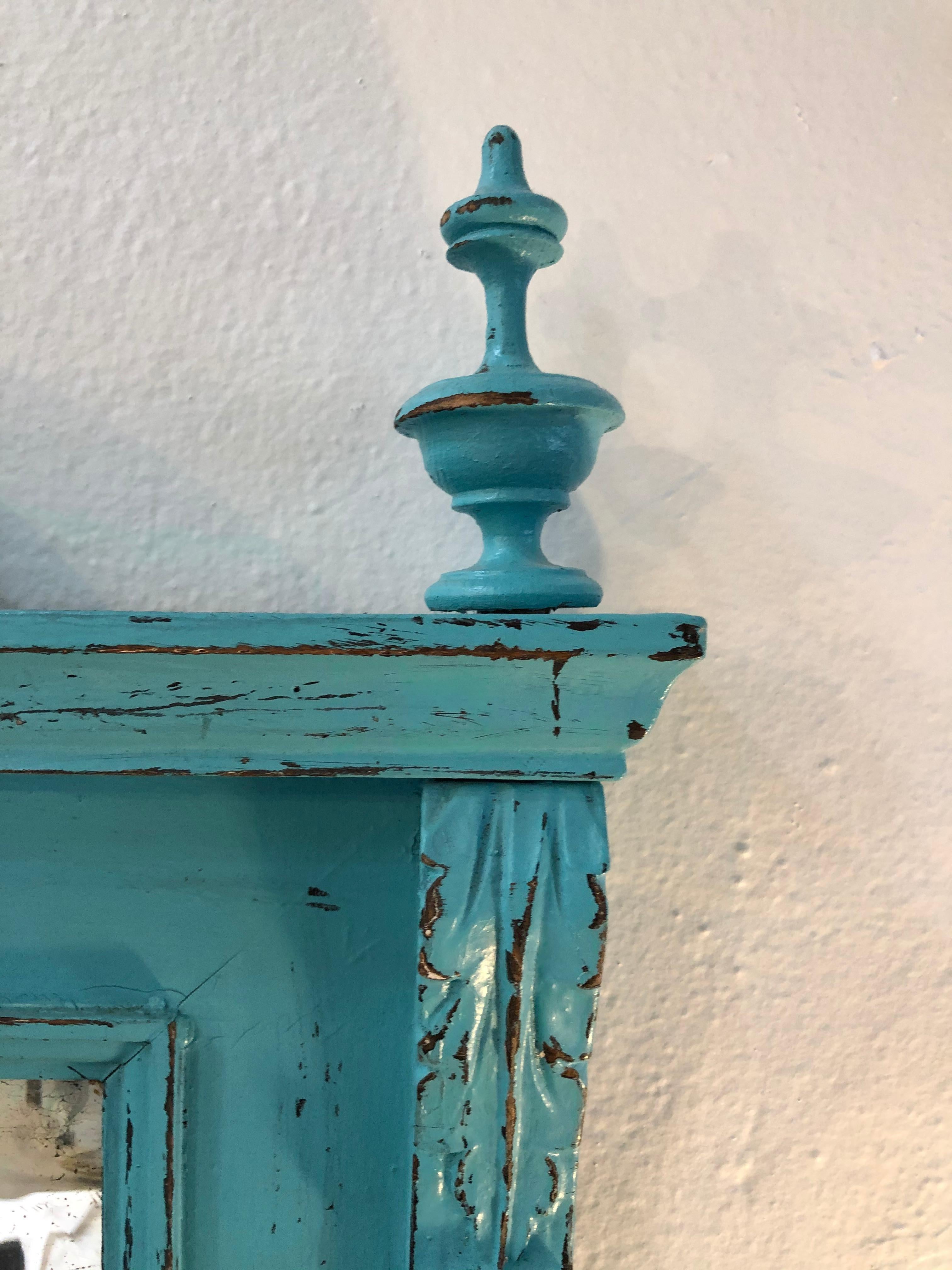 Vintage painted mirror in aqua blue is an early 1900s piece. Lovely size for any entryway, living room, bedroom space. Wood frame with carved design in arch.