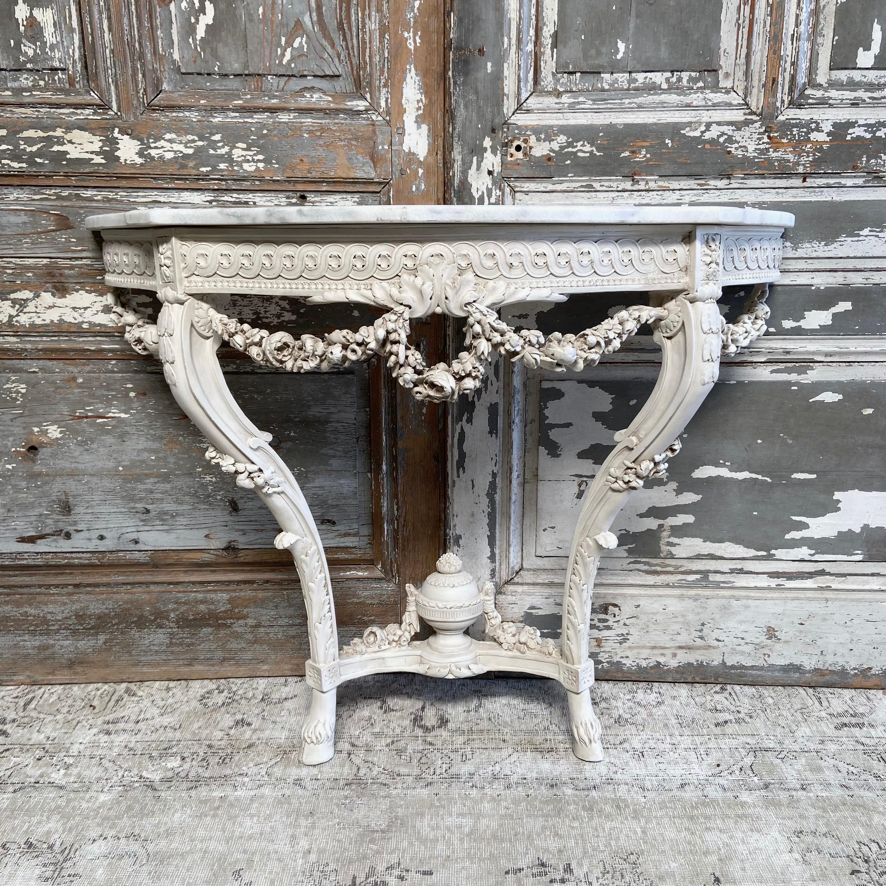 Vintage style painted french console with rose swags and marble tops
Painted in a french oyster white color, with subtle distressing and light glaze.
Marble top is not attached to the table base. 
Must be attached to wall.
Size: 45-1/2”w x 17”d