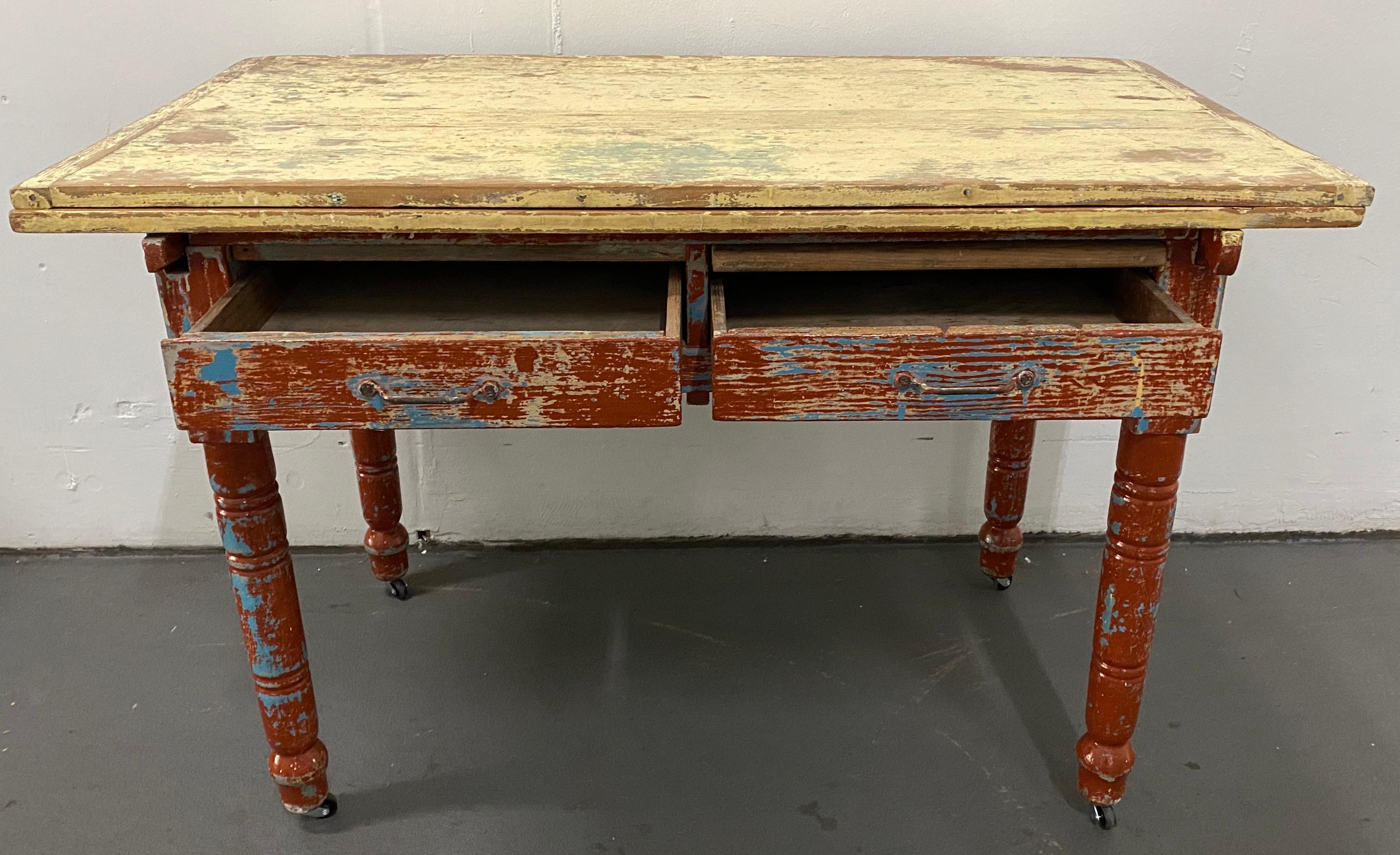Vintage painted table with two drawers and turned legs, circa 1930

This is a custom made table made from Pine. Turned legs, two drawers, a pull-out shelf and a stacked double board surface.

This would make a great kitchen counter, work desk,