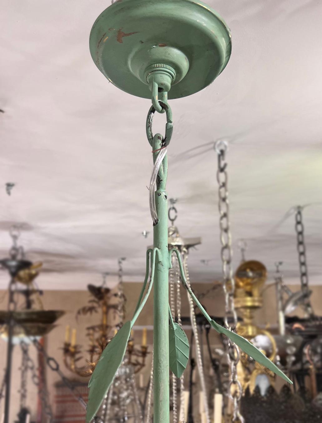 A circa 1960's Italian painted tole chandelier with 8 lights.

Measurements:
Present drop: 36.5