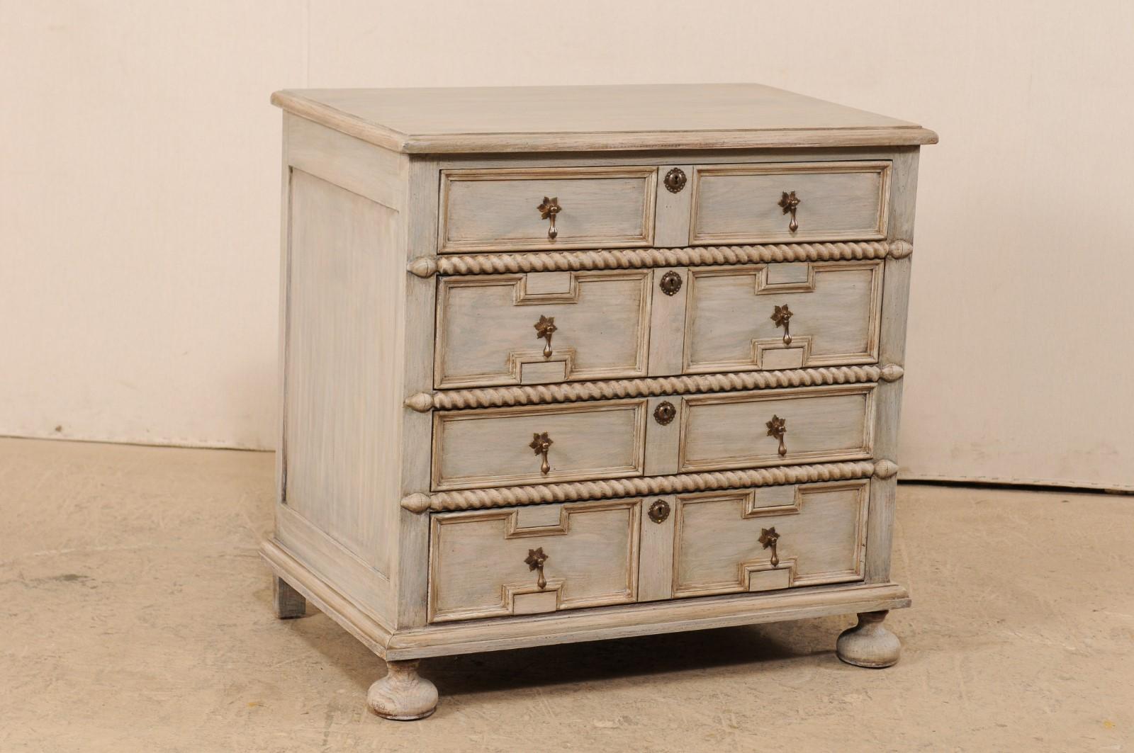 A mid-20th century carved and painted wood chest of drawers from American furniture makers Banks, Coldstone Co. (Deep River, High Point, NC). This vintage chest houses four drawers, with second and fourth drawers beautifully carved with a pair of