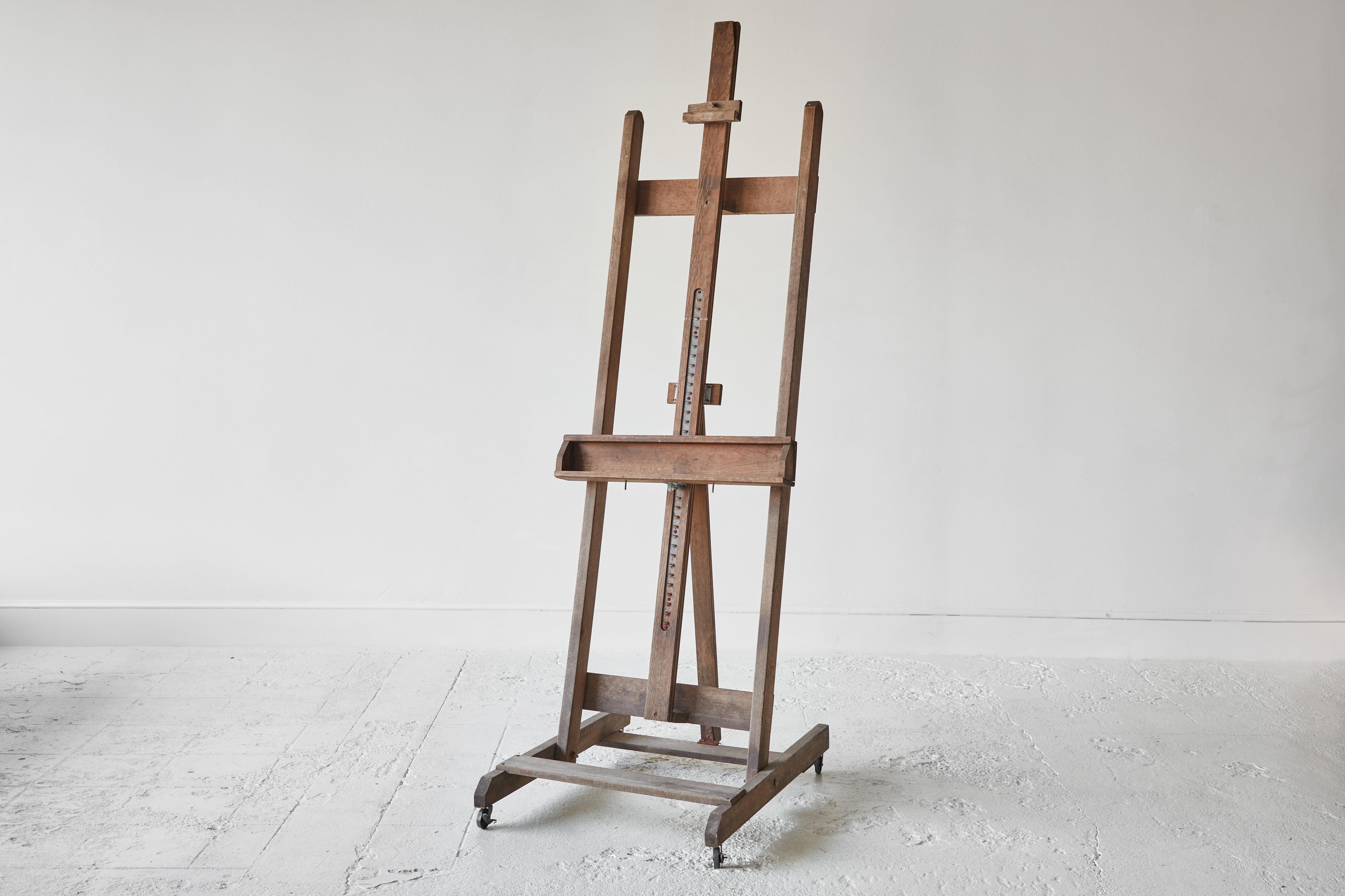 Vintage wooden painters easel with adjustable placements. This piece is one of a kind and unique.