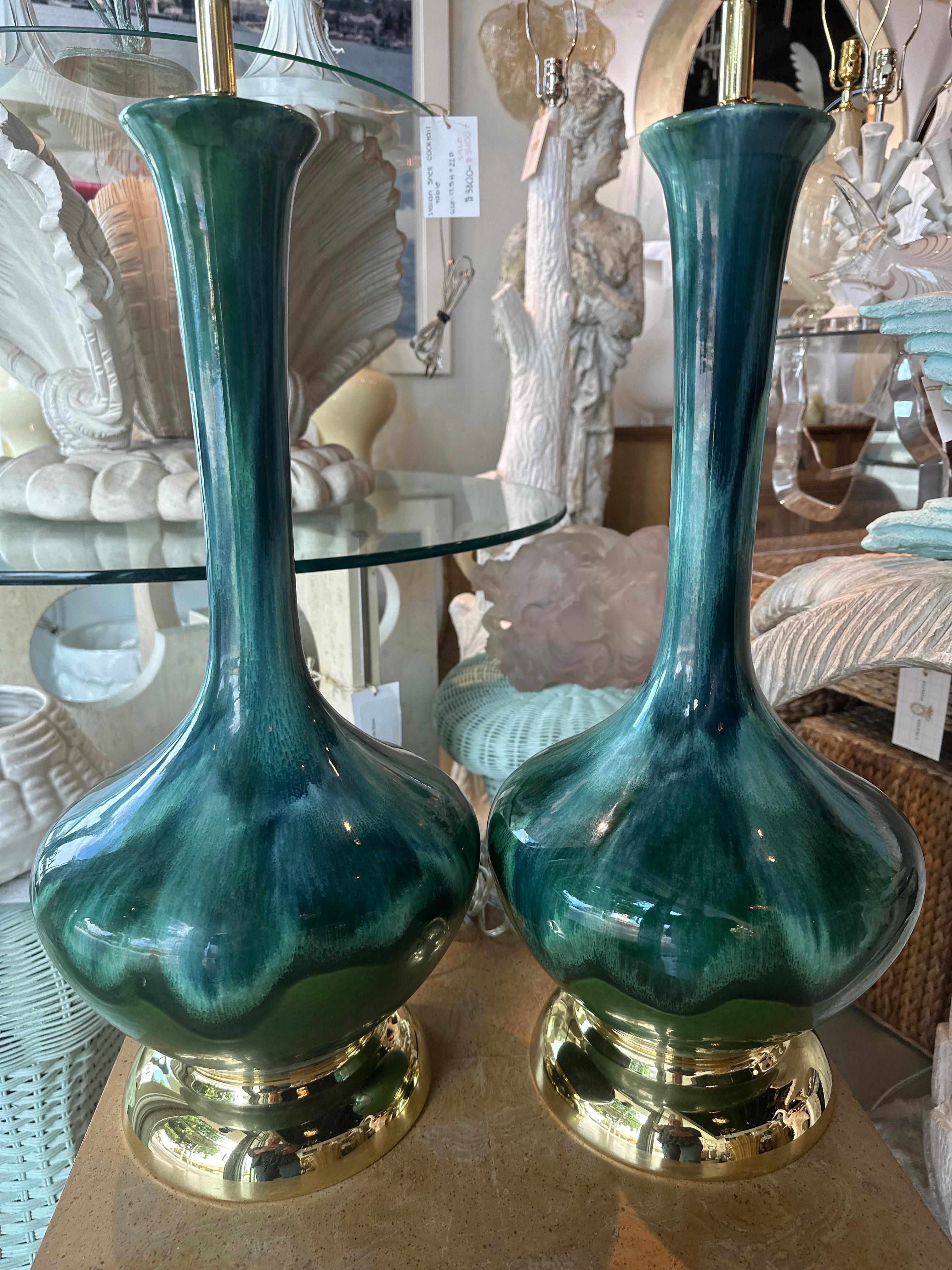 Vintage pair of beautiful blue green drip glaze ceramic table lamps with original brass bases they we had newly plated in brass. These have been newly wired, 3 way all brass sockets and hardware, clear cord, finial and harp. 100% restored to