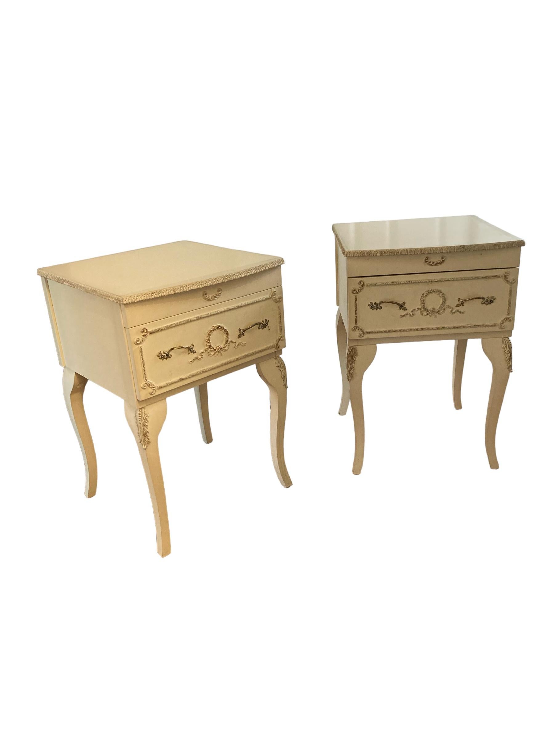 Vintage Pair of Bedside tables or Nightstands French Antique Style, cream finish with brass handles. This set of two bedside cabinets have a signgle drawer with two ornate handles and cabriole style legs  will suit any style of interior
