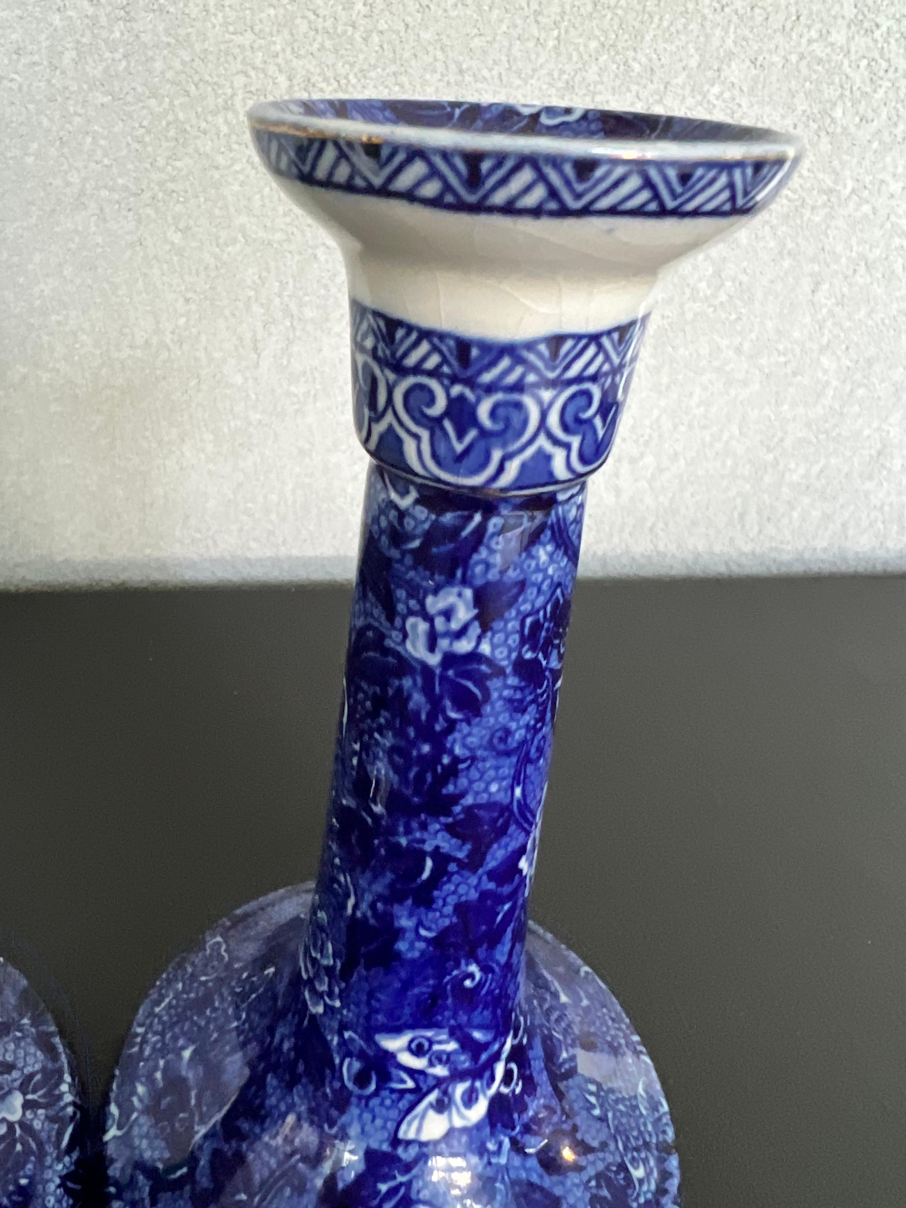 Gorgeous pair of porcelain hand-painted candlesticks made by Shelly in England 
Deep blue color is striking, the rim has lost the gold edge but they still look amazing and would add a touch of color to any room 
stamped and number on bottom  