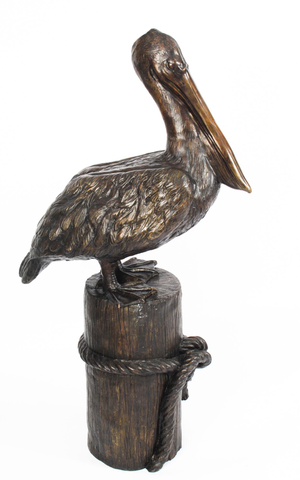 This is a splendid large pair of solid bronze pelicans on mooring posts, dating from the late 20th century.

This charming pair feature one pelican sitting and one standing tall, each on a mooring post with rope entwined around it. 

This