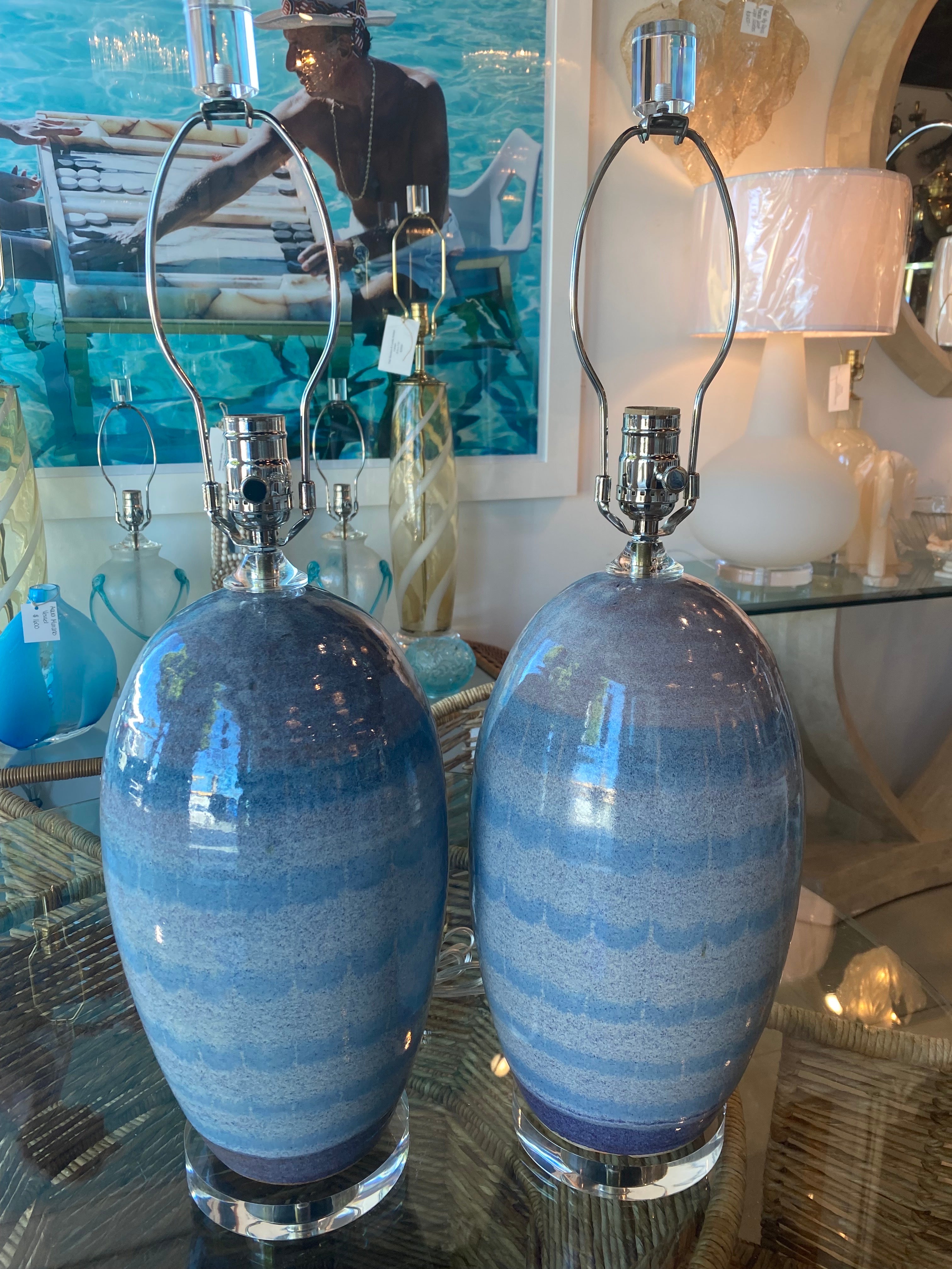 Vintage pair of ceramic pottery table lamps, ombre blue and lavender. Restored to perfection with all new 3 way sockets, all new nickel hardware, lucite base, lucite finials and lucite vase cap. Dimensions: 18 H to socket x 25.5 H to finial x 8 D.