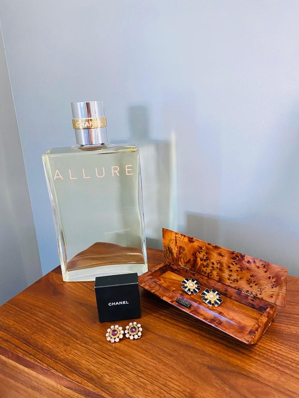 Classic Chic!  Incredible pair of vintage Chanel earrings. The pair features a purple Gripoix glass center with surrounding crystals on a 24k gold plated disk with clip. Very few pieces carry the heritage of classic timeless fashion and these
