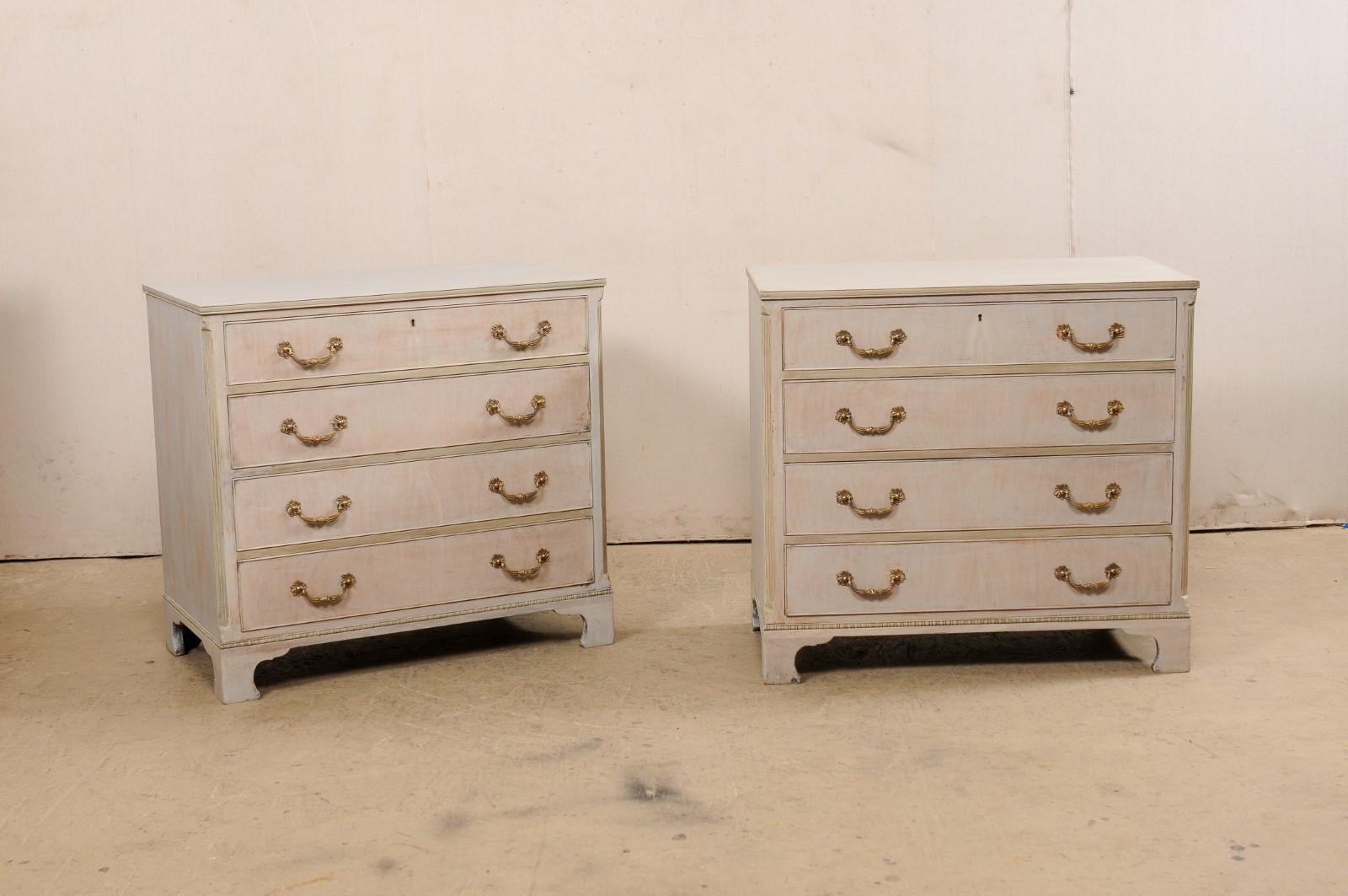 A pair of painted wood chests from American furniture maker Kittinger Furniture. These vintage made-in-America chests each feature a rectangular-shaped top over a has which houses four graduated and dove-tailed drawers, set within canted and