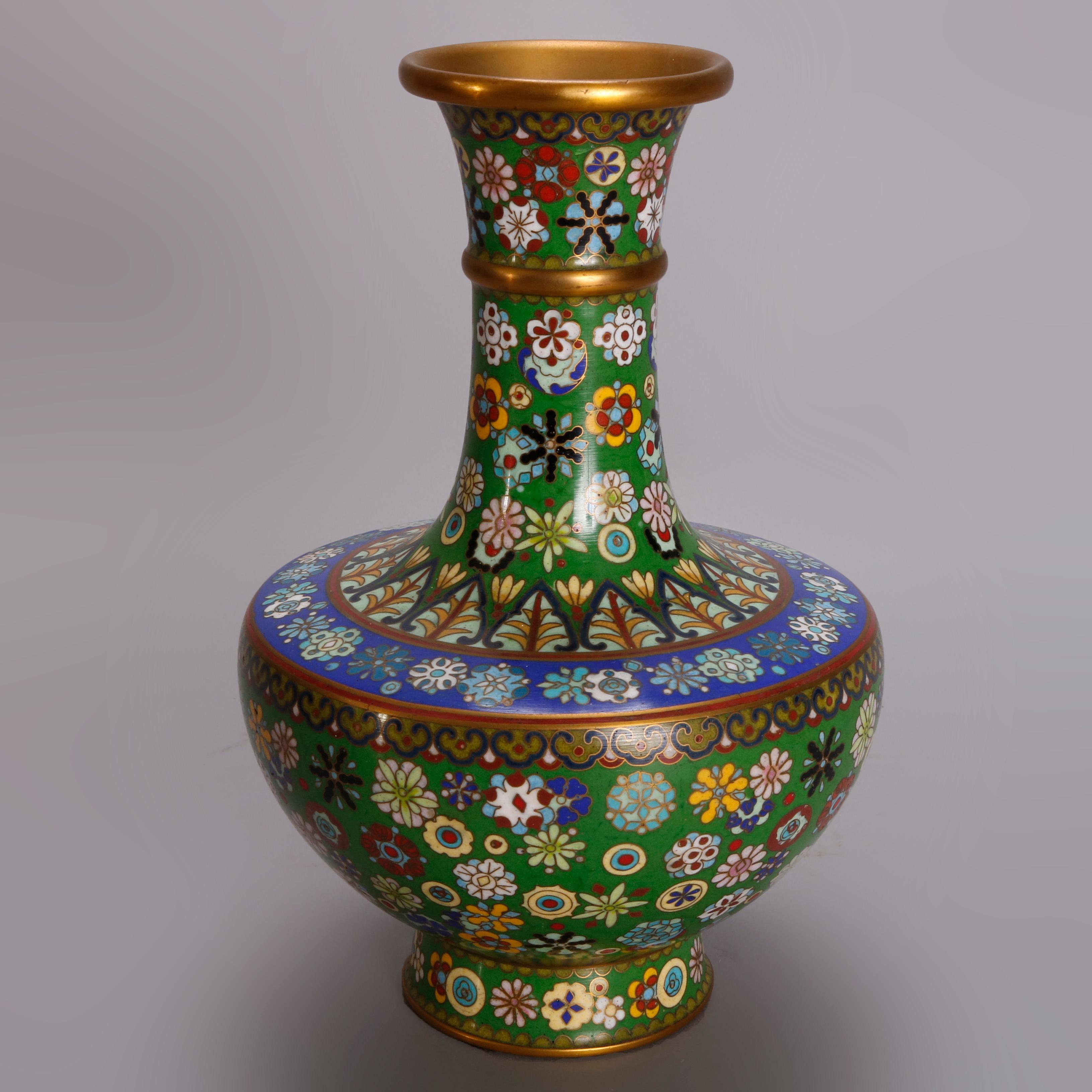 A pair of matching vintage Chinese Cloisonne vases offer urn form with all-over hand enameled floral decoration on emerald green ground with sapphire blue banding, 20th century.

***DELIVERY NOTICE – Due to COVID-19 we have employed