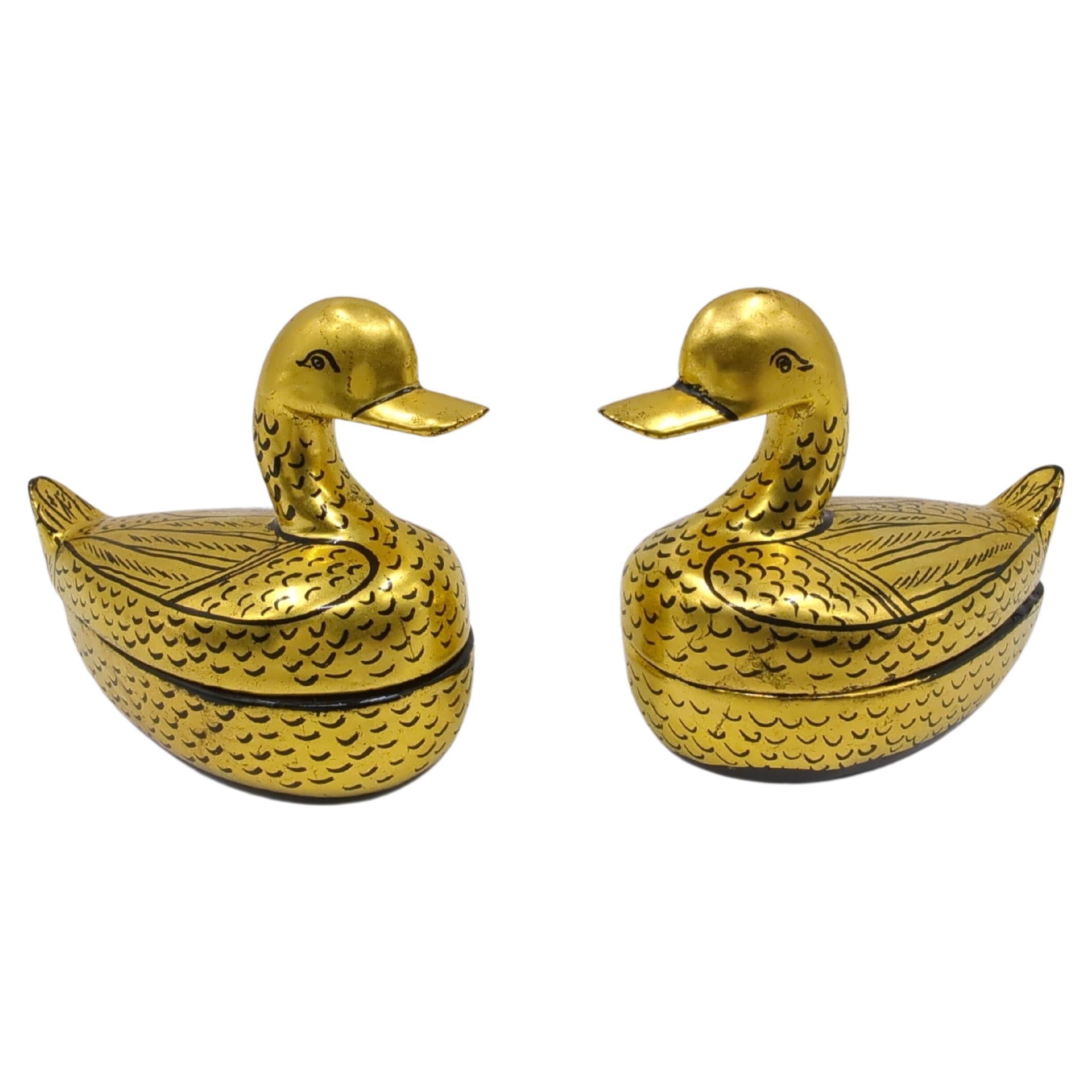 A wonderful pair of mid century Chinese lacquer covered box in the form of Mandarin ducks, hand decorated with black details on gilt gold ground.

This pair of golden covered boxes are truly lovely objects to house your little treasures like those