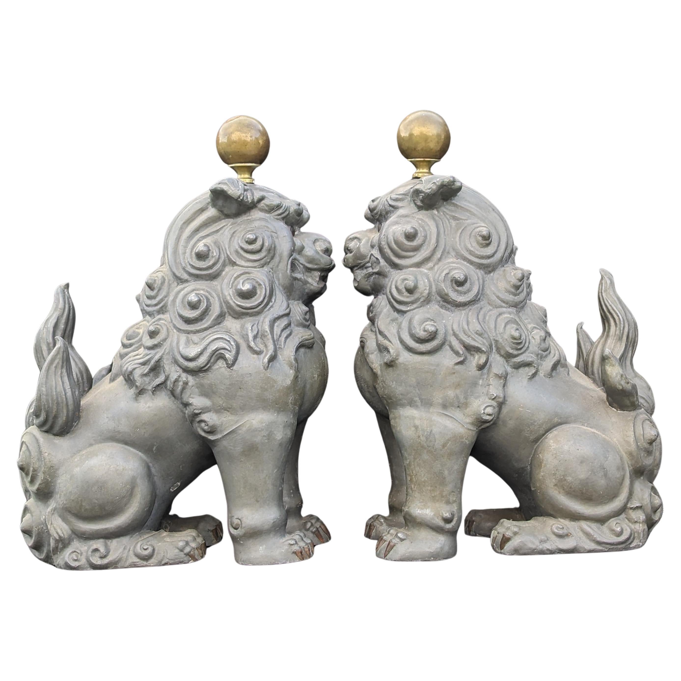 Pair of vintage Chinese pewter guardian lions, in fierce sitting pose, with copper accents for sharp claws, and each topped with an adjustable height brass ball attached by a threaded rod.

circa: 1950, Mid 20c

Hallmarks: MADE IN HONG KONG and NG